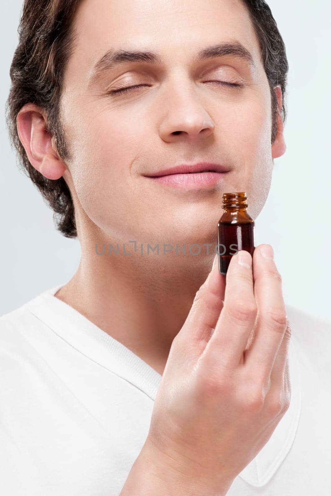 Man smelling aromatherapy oil