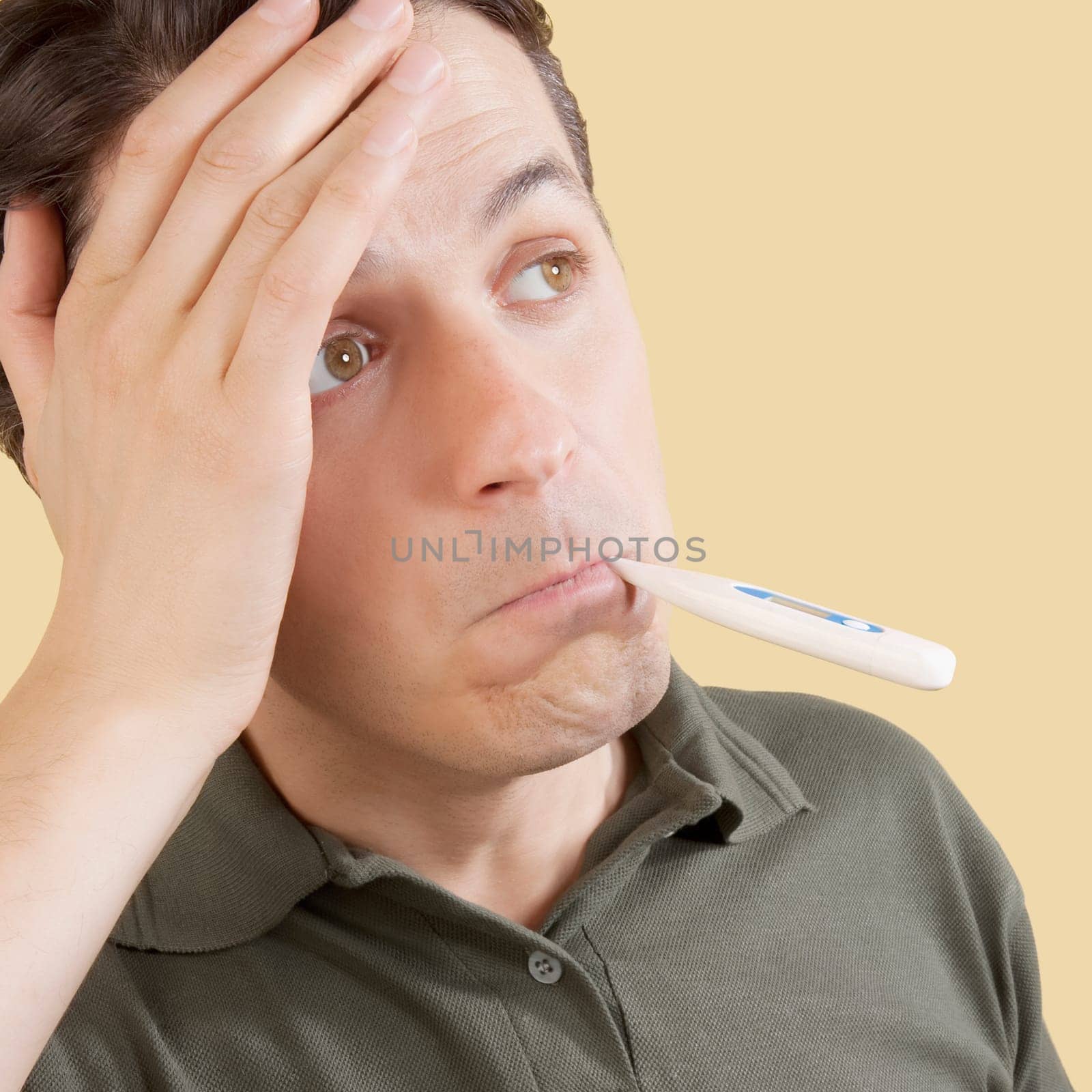 Man checking his temperature with a thermometer