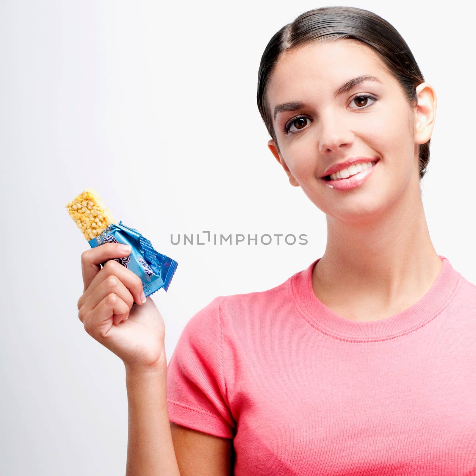 Portrait of a woman holding a protein bar