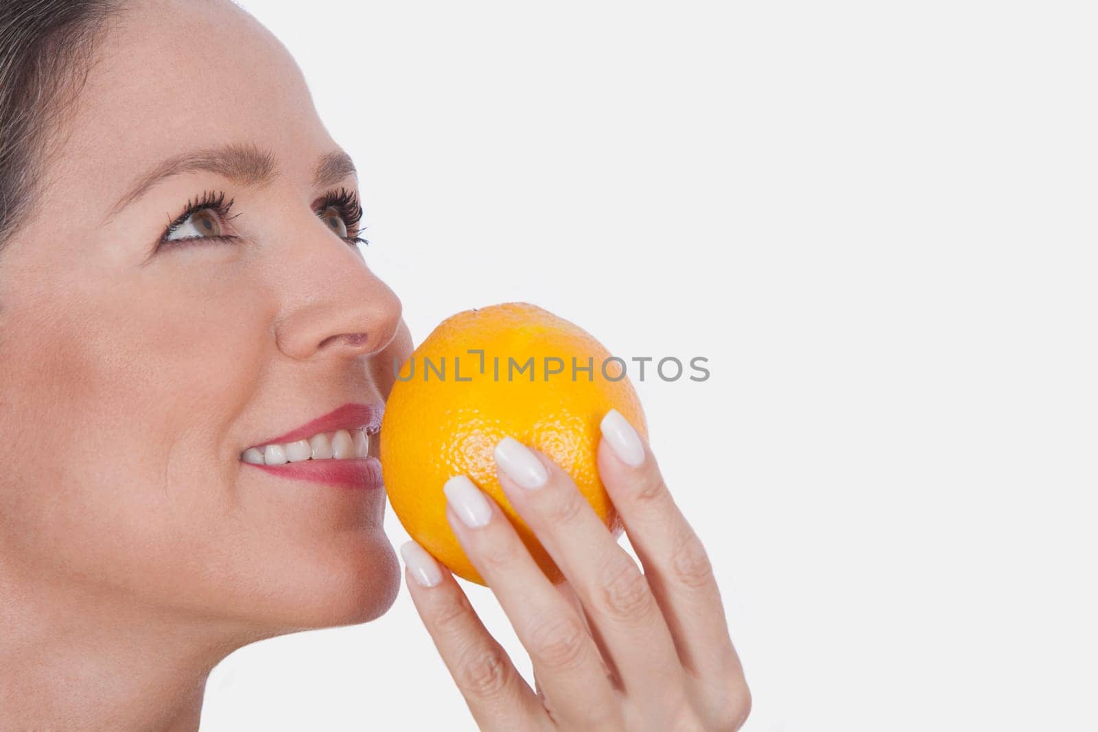 Woman smelling an orange
