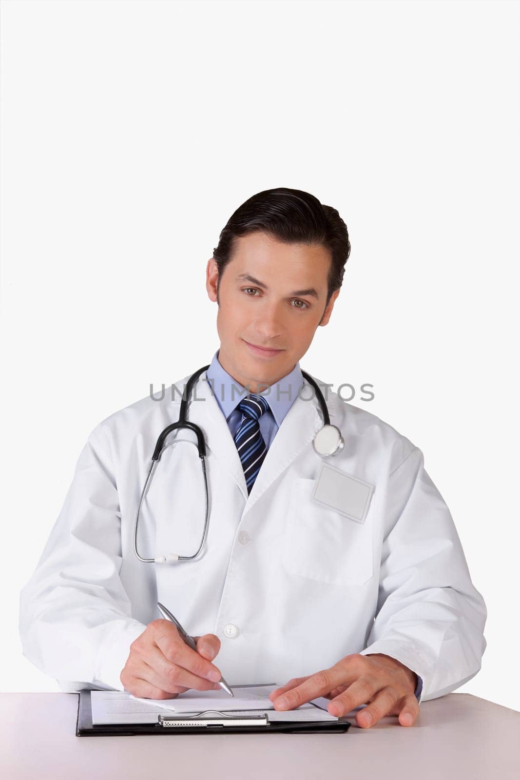 Portrait of a doctor writing on a clipboard