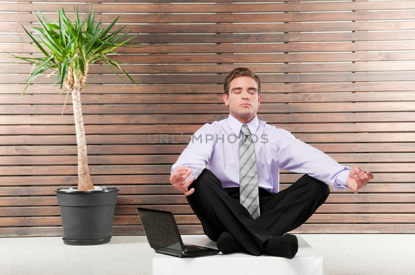 Businessman practicing yoga