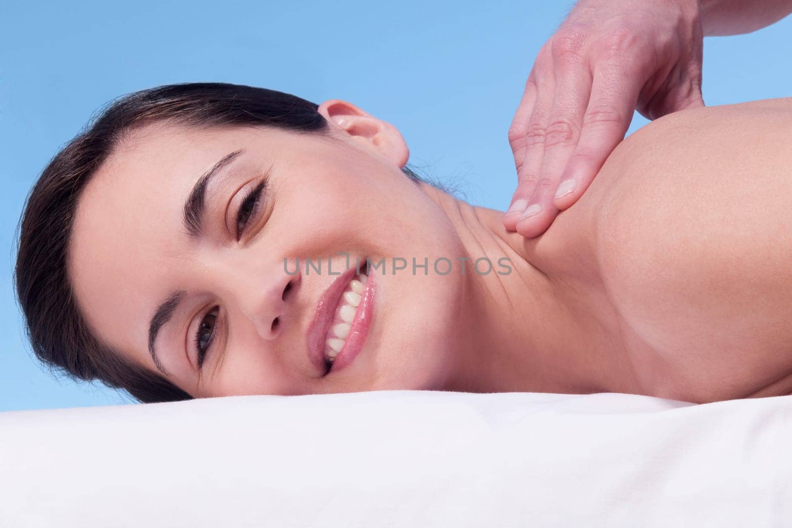 Woman receiving back massage from a massage therapist