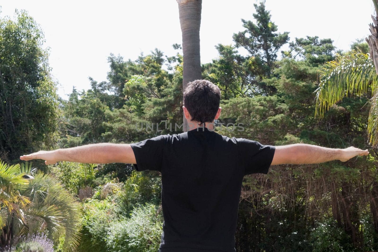 Man practicing yoga in a park