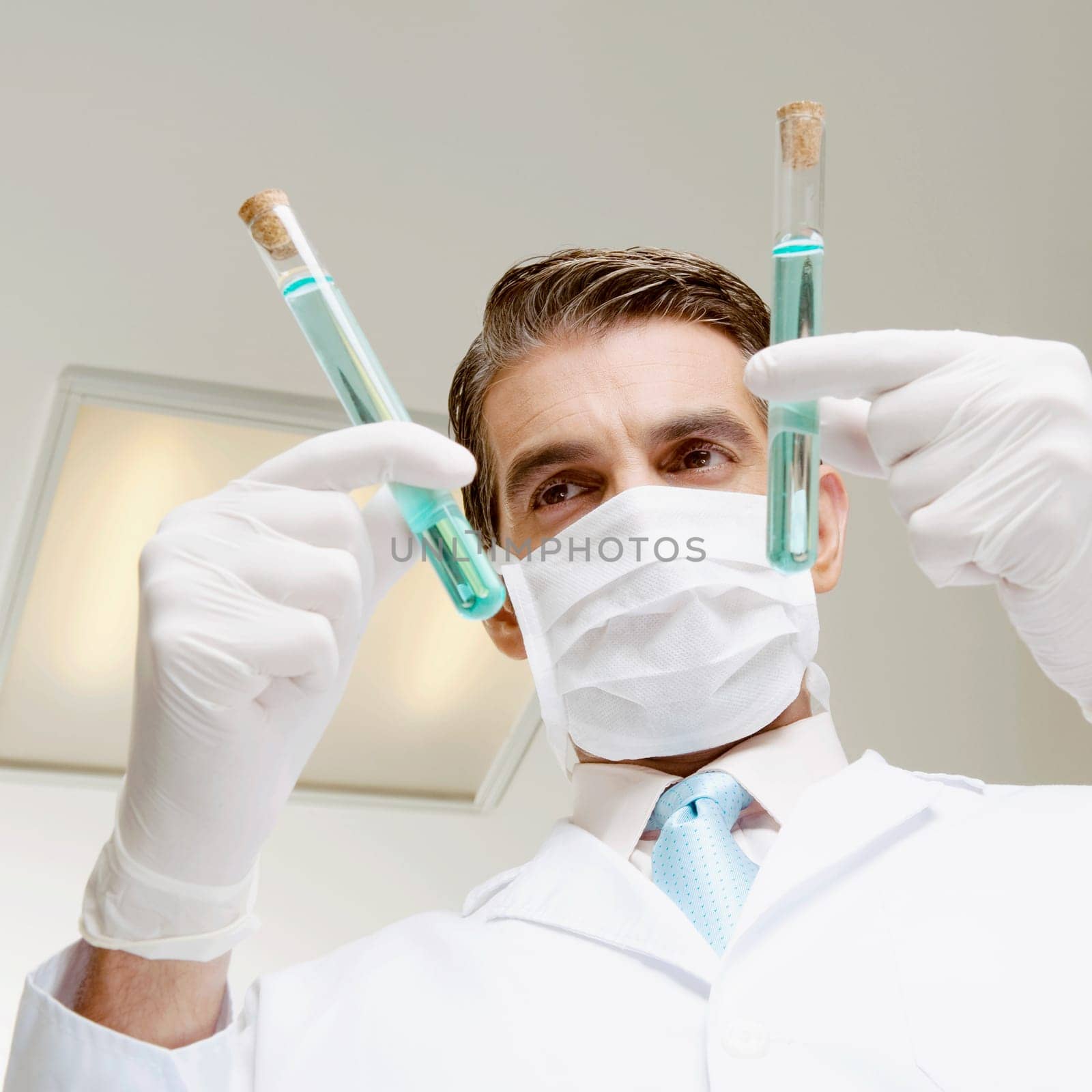 Lab technician analyzing sample in test tubes