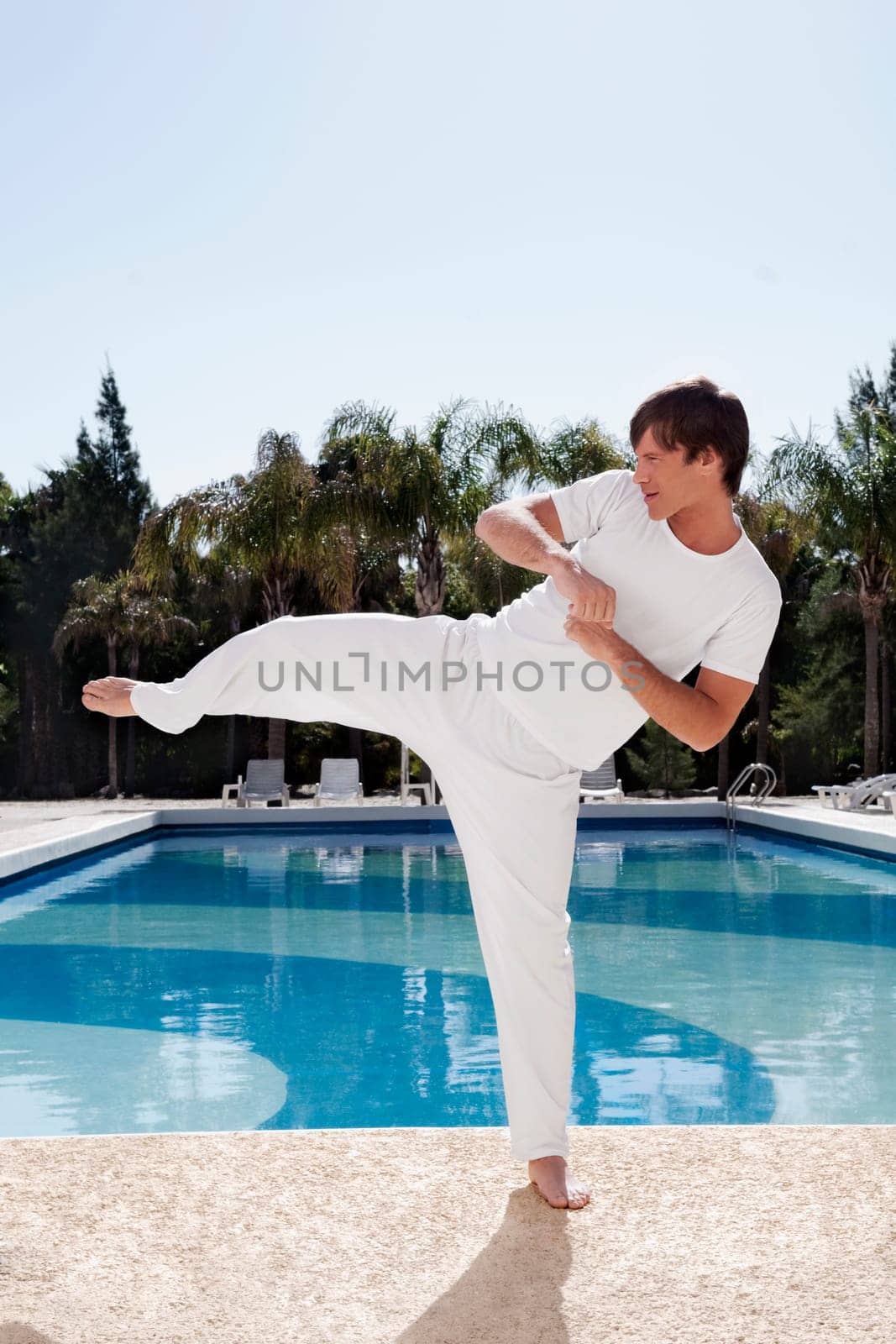 Man exercising at the poolside