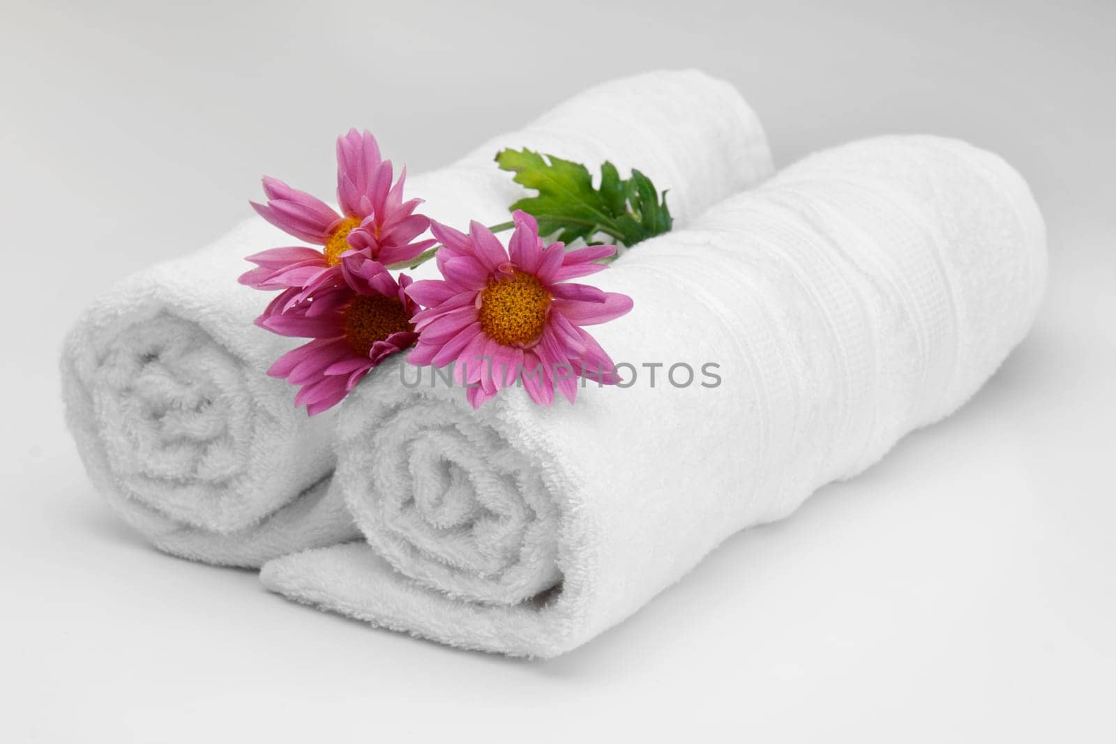 Close_up of rolled up towels with flowers