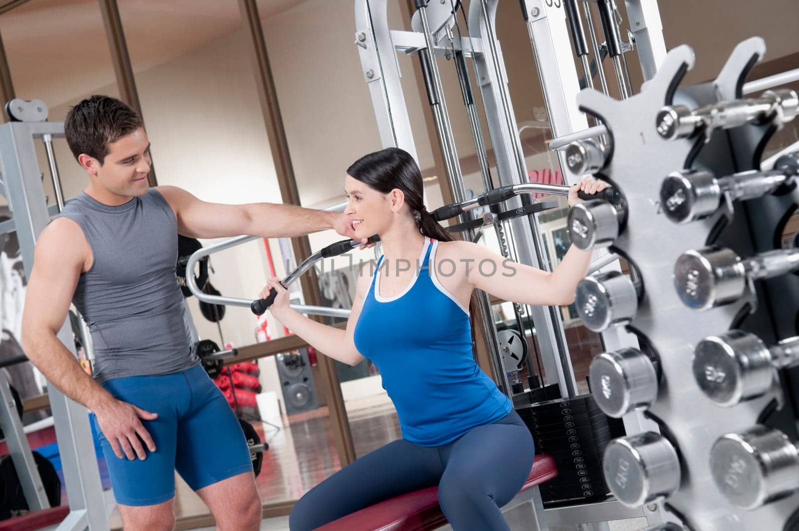 Male instructor helping a woman in exercising