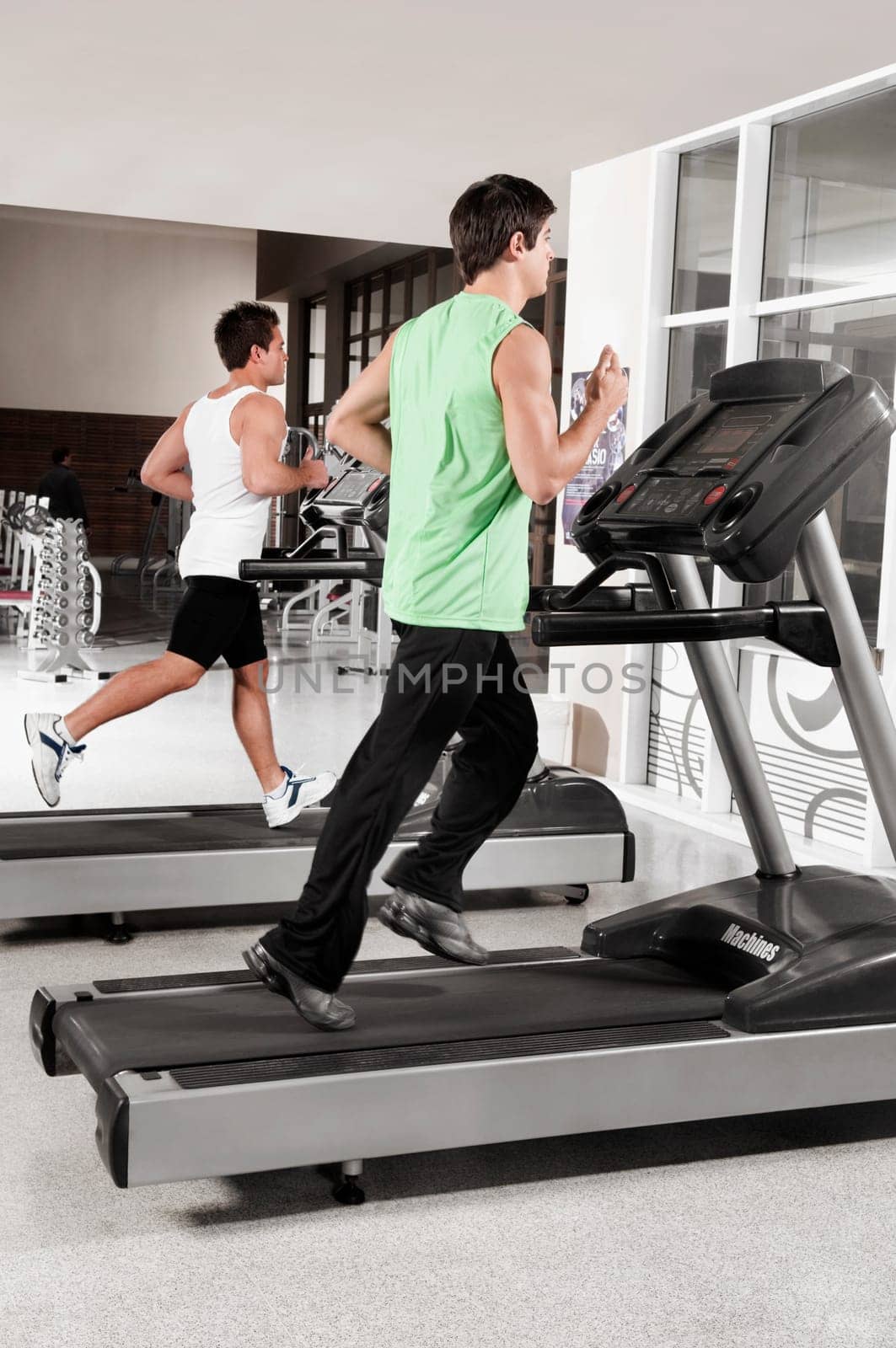 Two men running on treadmills