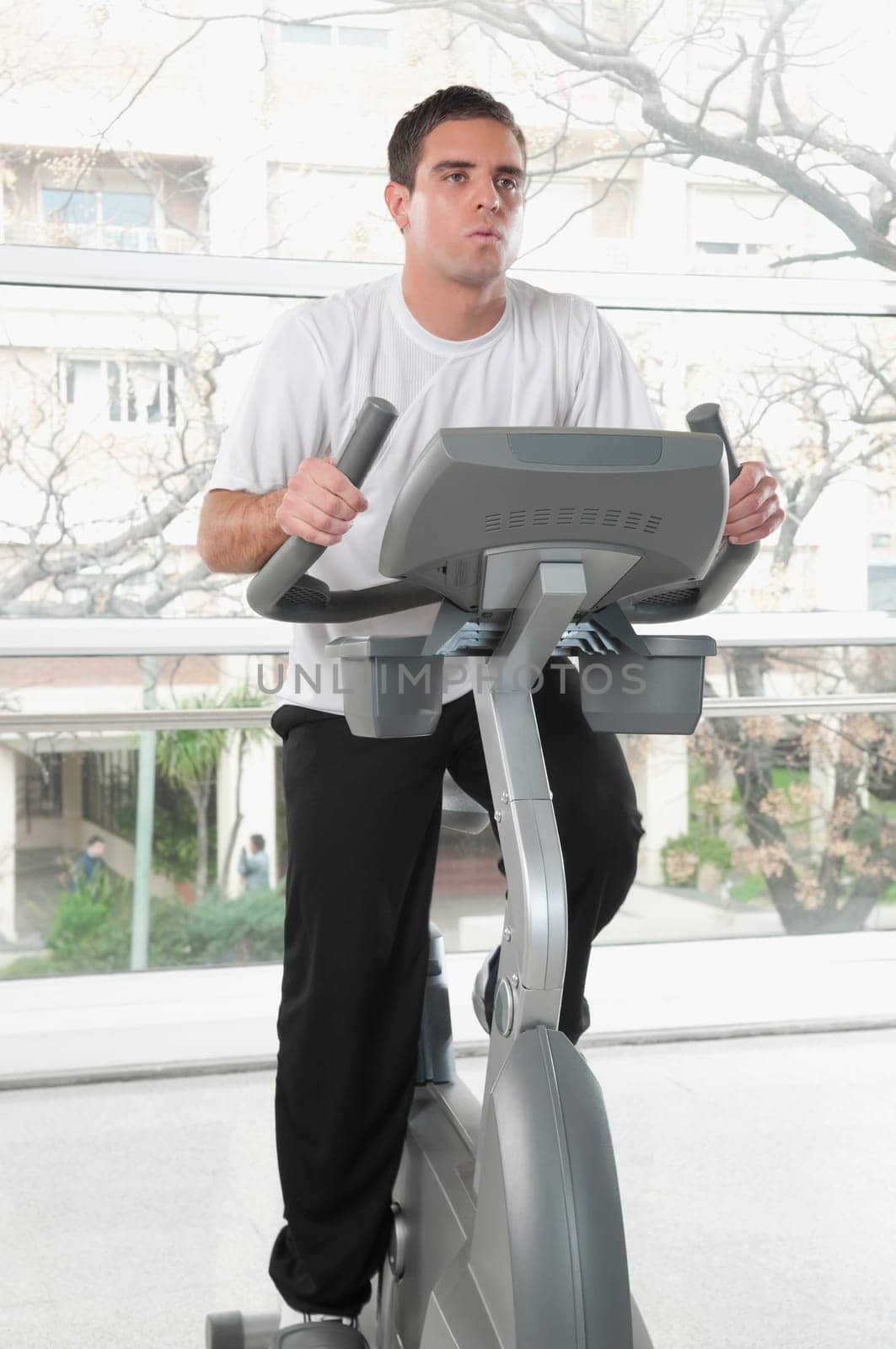Man working out on an exercise bike in a gym