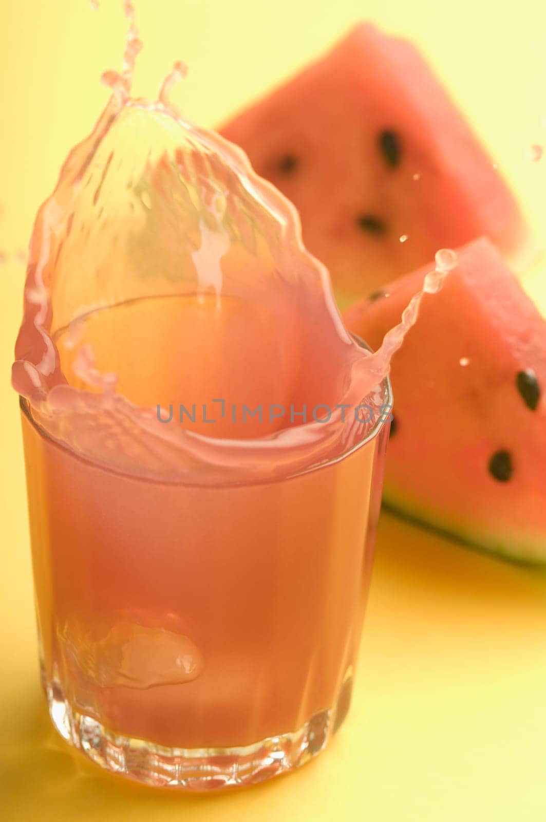 Close_up of watermelon with a glass of watermelon juice