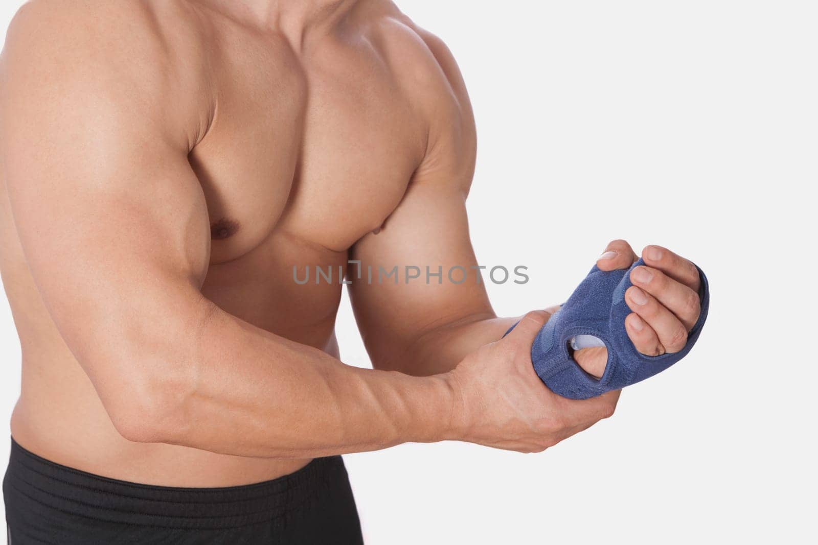 Mid section view of a man holding his wrist
