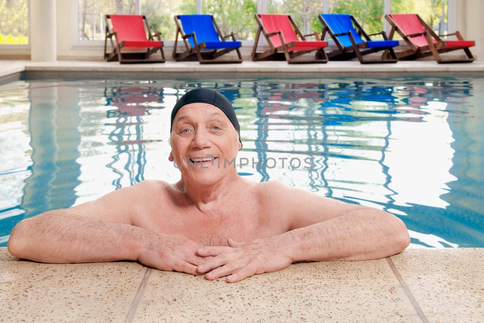 Portrait of a man leaning at the edge of a pool