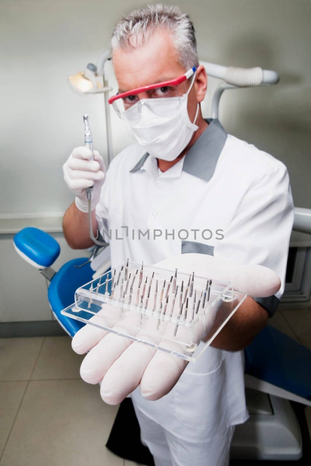 Dentist holding dental drill bits