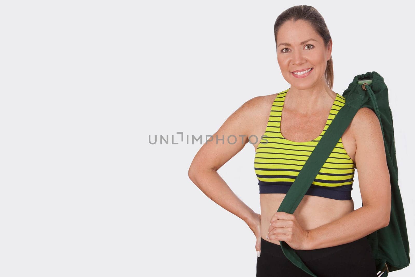 Portrait of a woman carrying a bag and smiling
