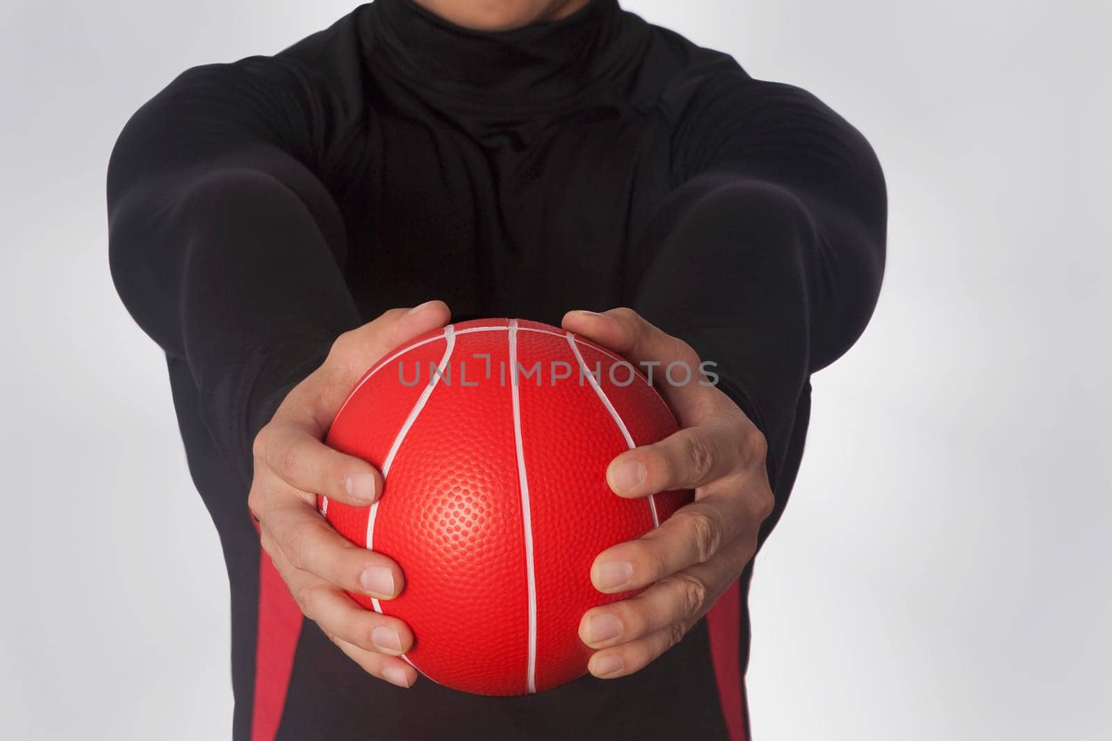 Mid section view of a man exercising with a medicine ball