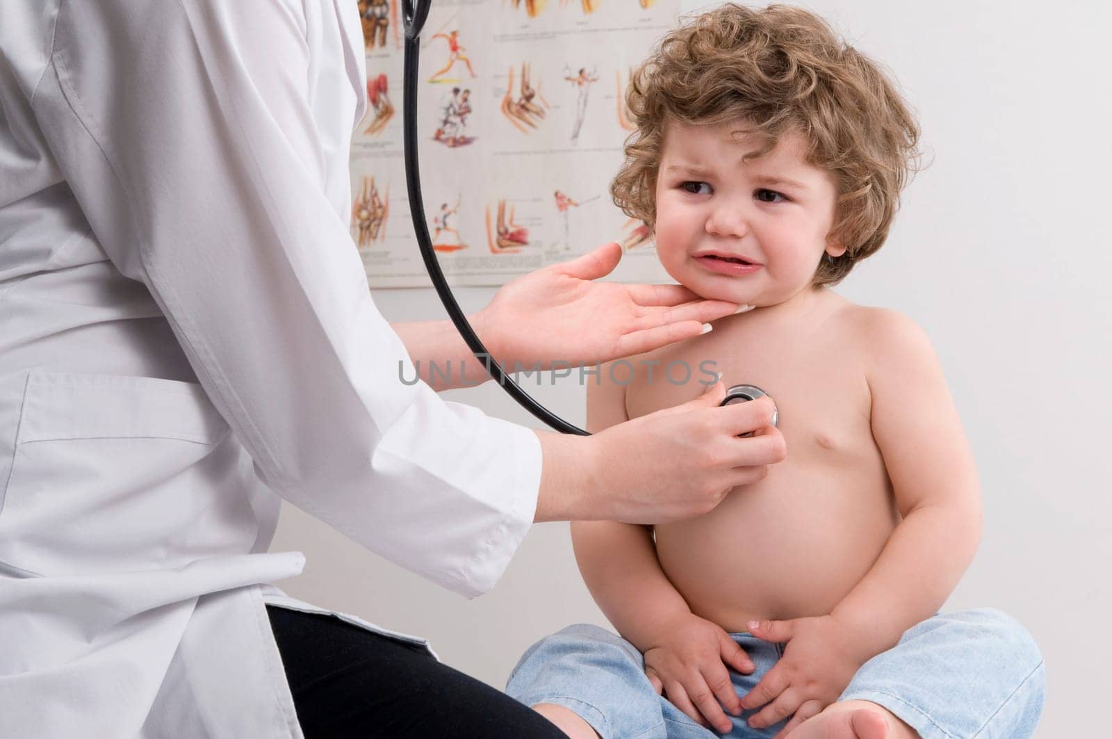 Female doctor examining a baby boy with a stethoscope