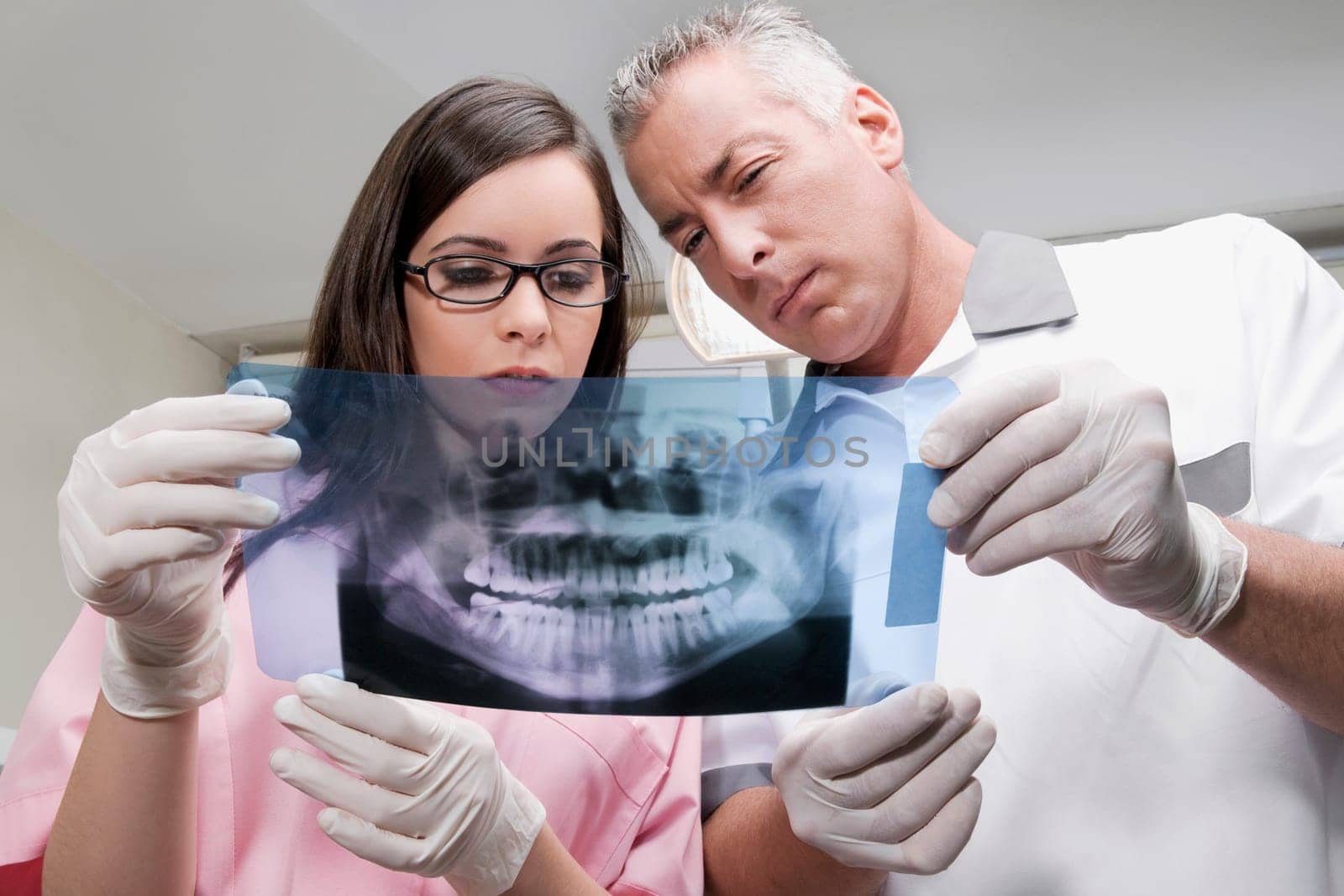 Two dentists examining an X_Ray report