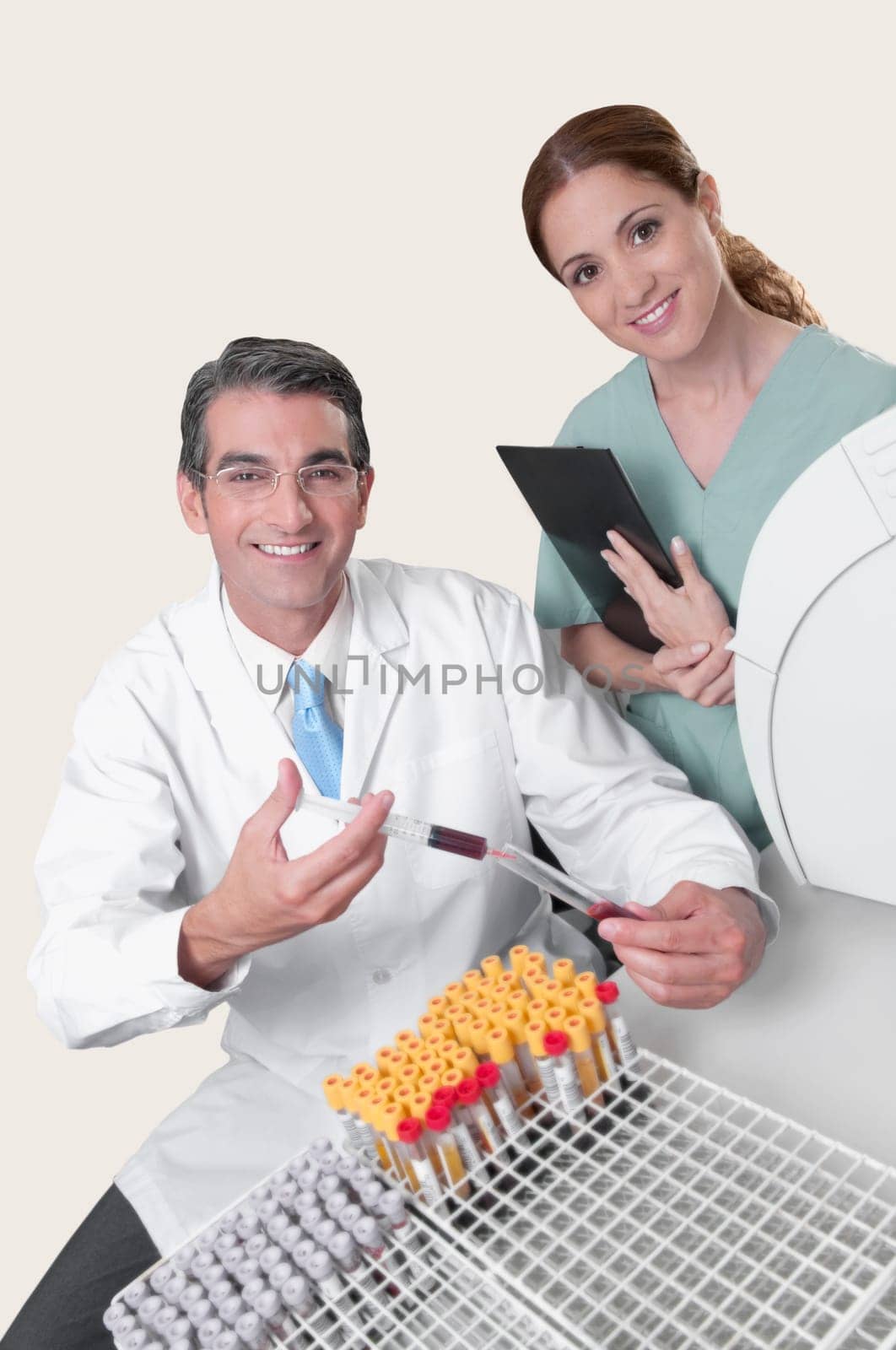 Lab technician filling blood in a test tube from a syringe