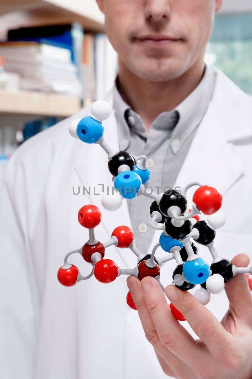 Doctor holding a molecular model in a laboratory
