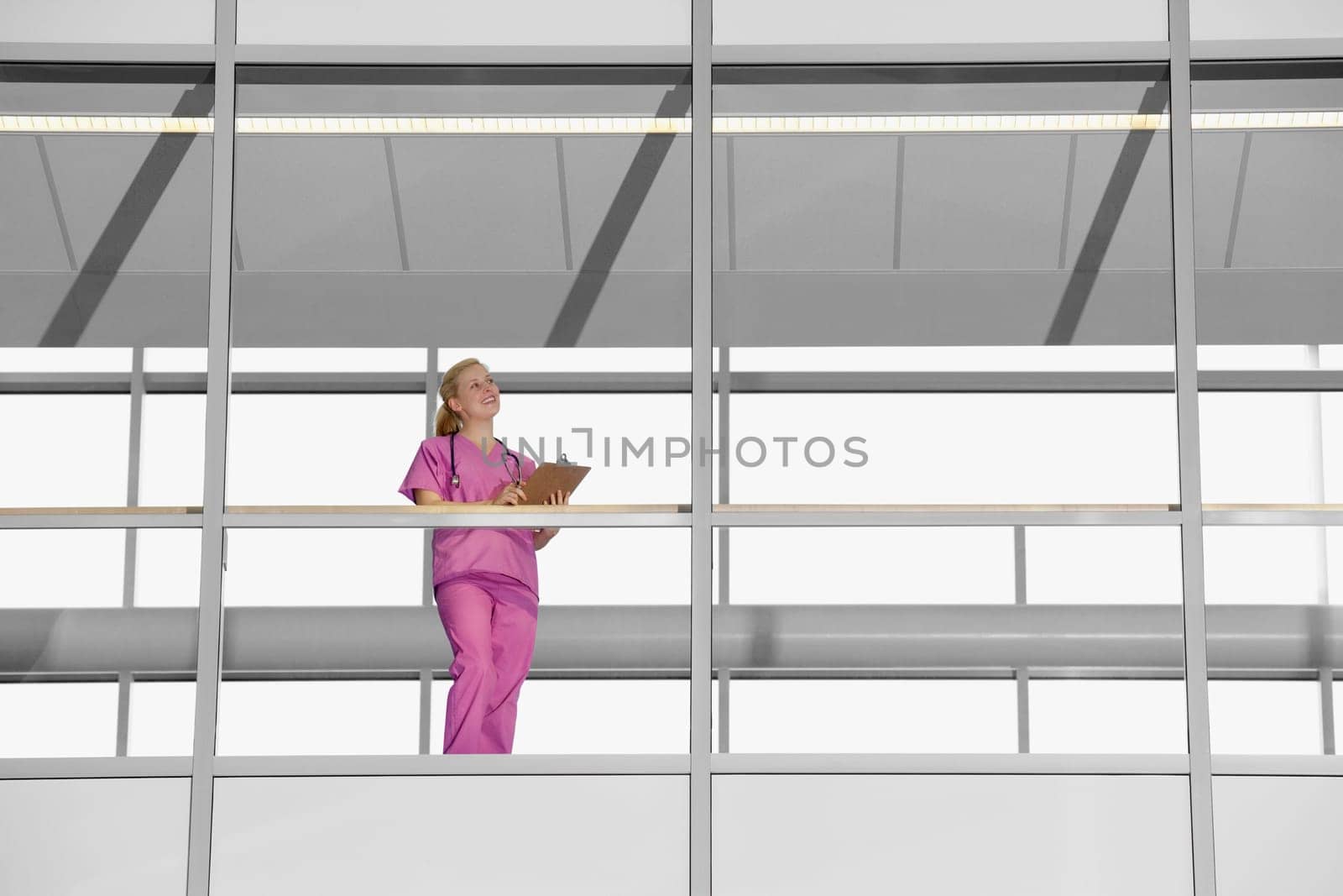 Female doctor writing on a clipboard