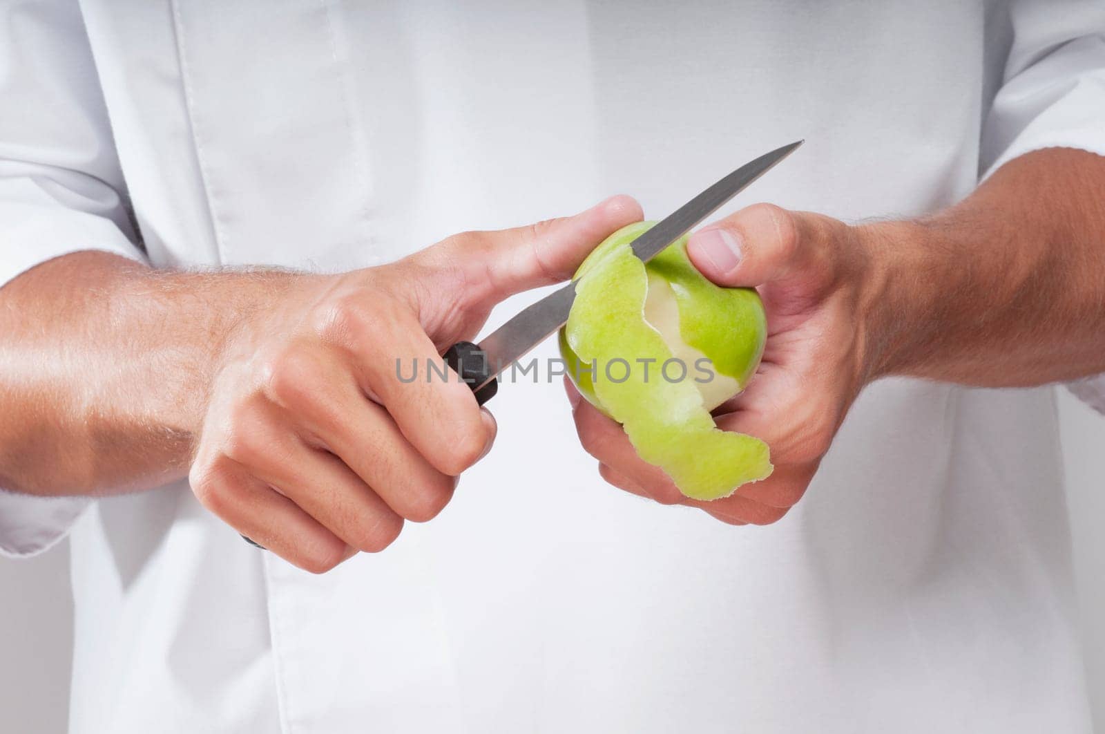 Man peeling a granny smith apple