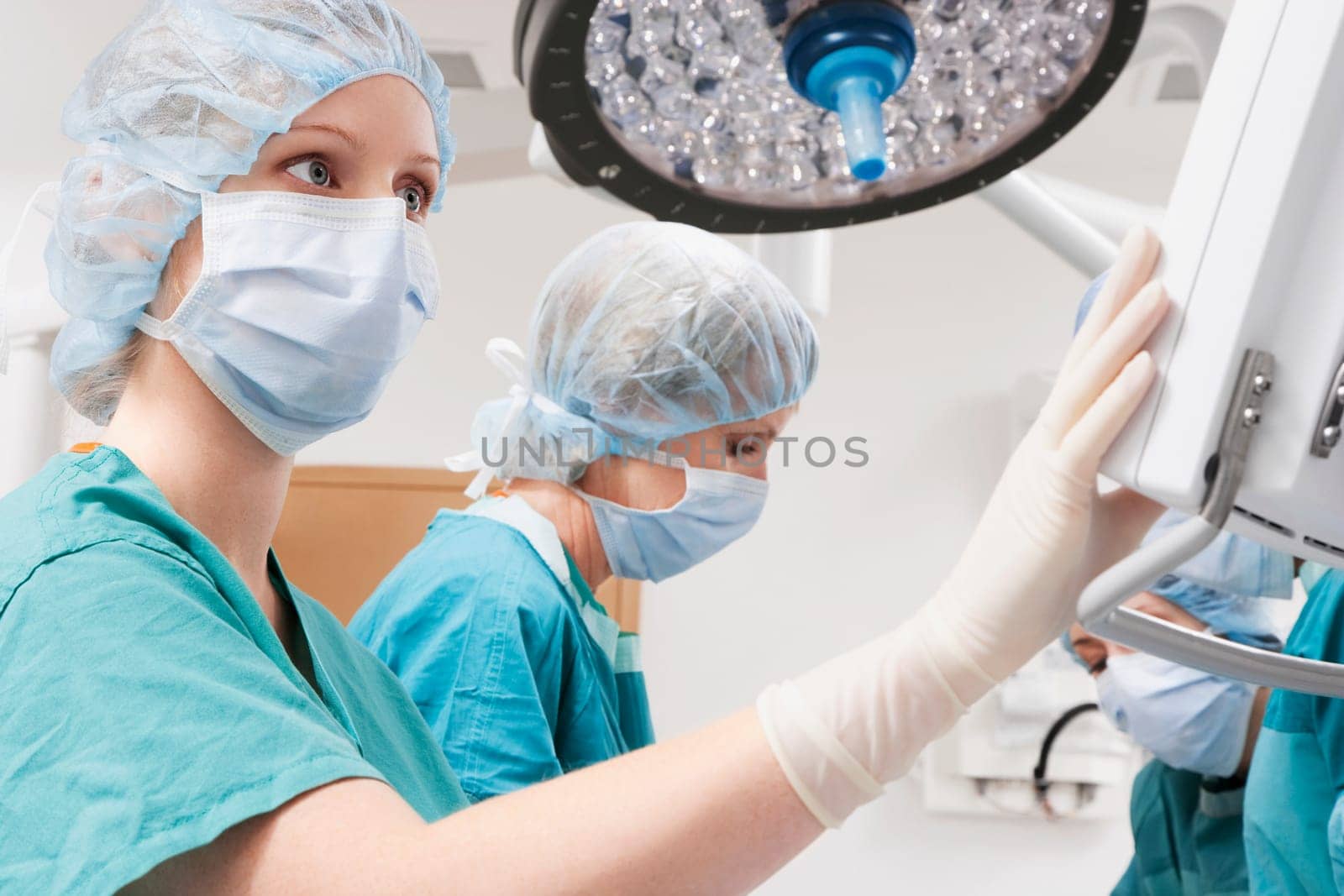 Surgeons performing a surgery in an operating room