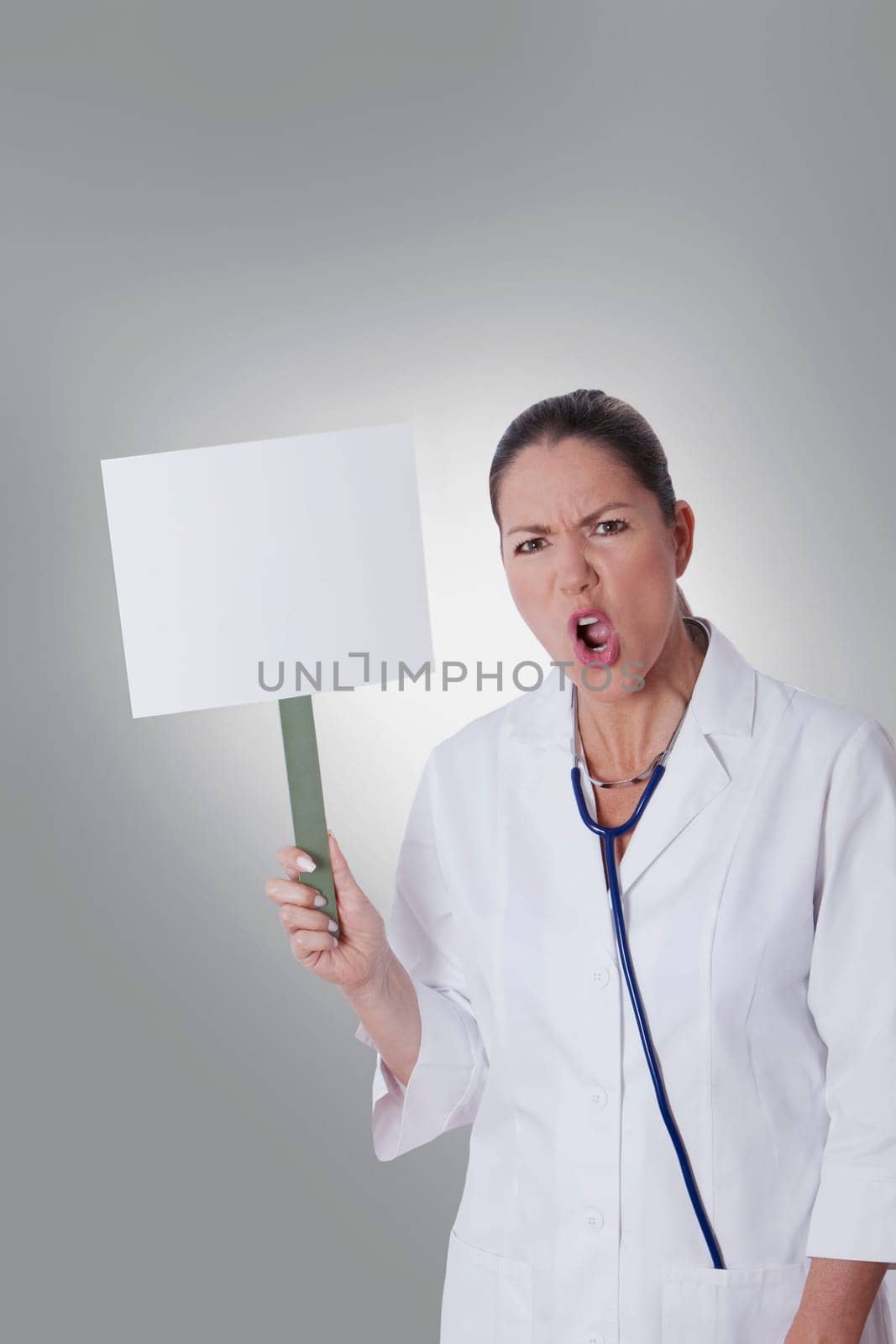 Female doctor holding a blank placard