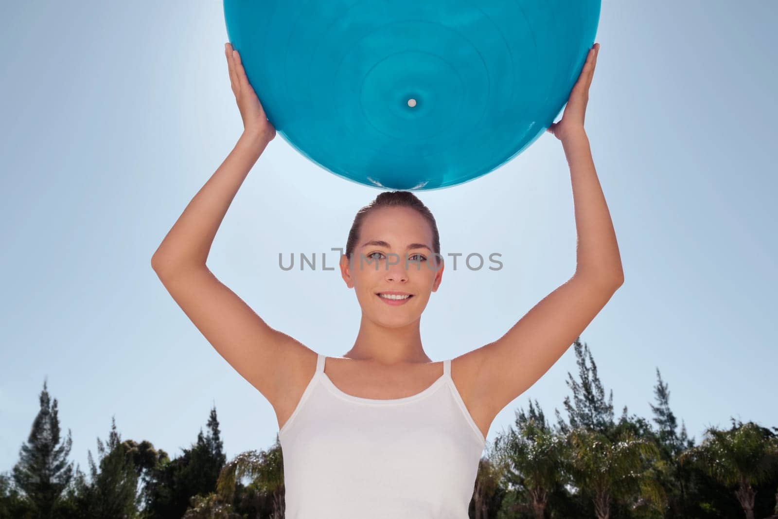 Woman holding a fitness ball and smiling