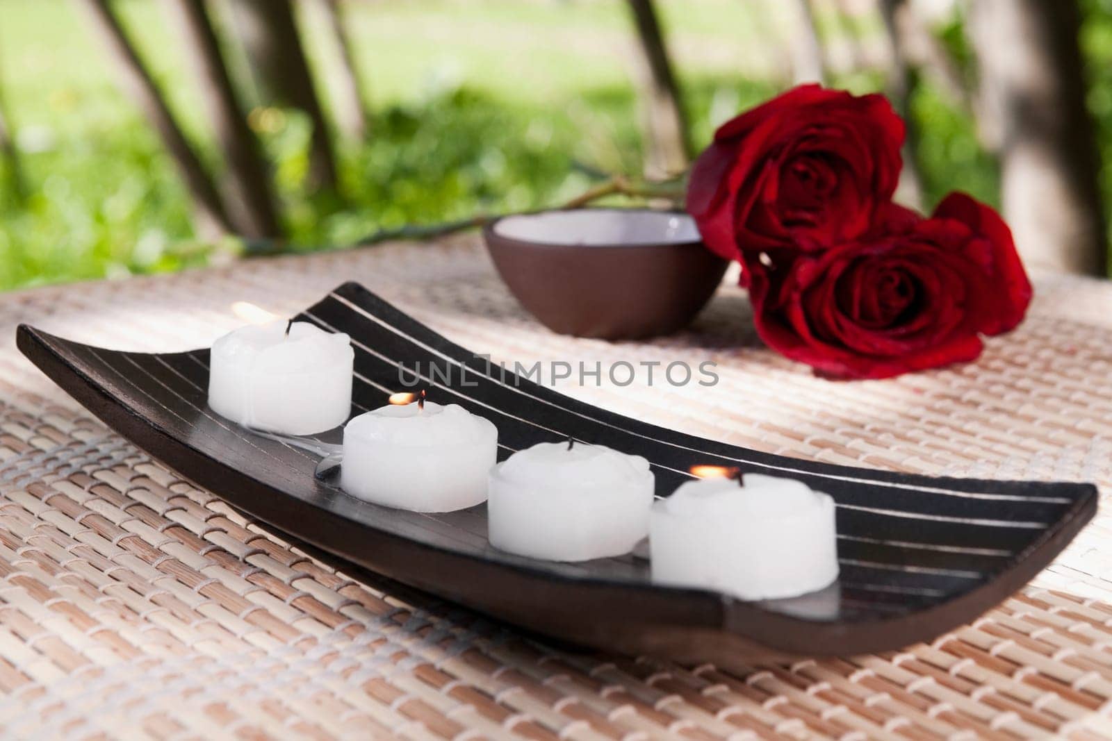 Candles on a tray with red roses