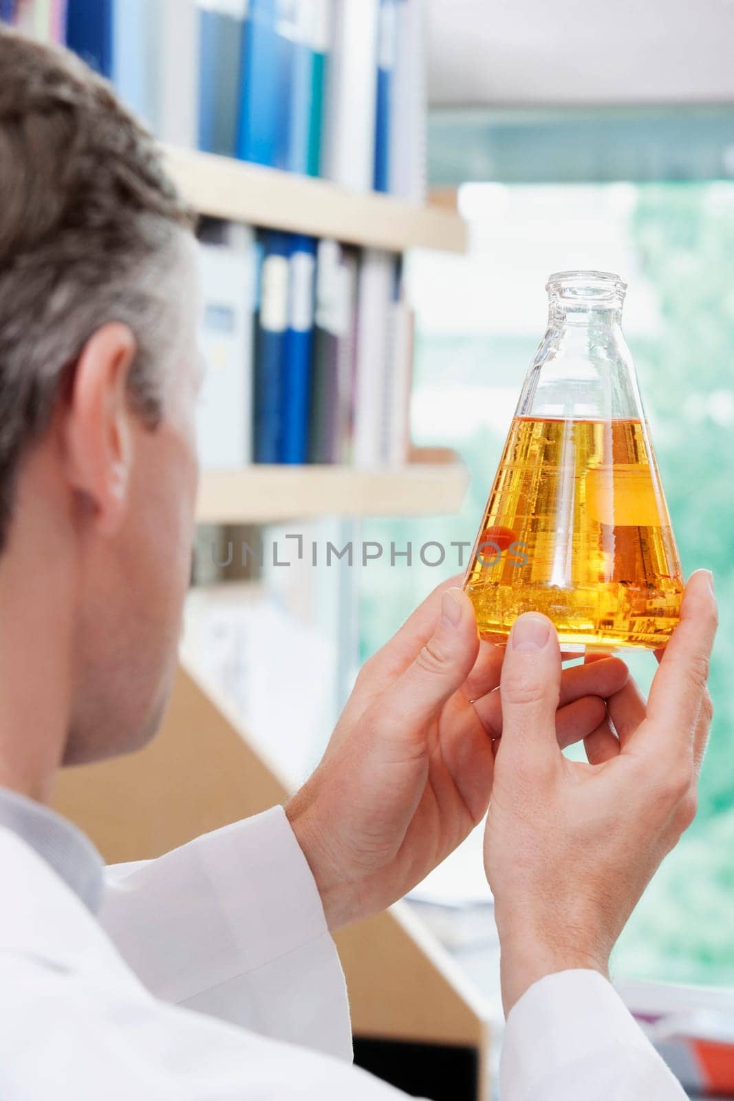 Doctor holding a conical flask in a laboratory