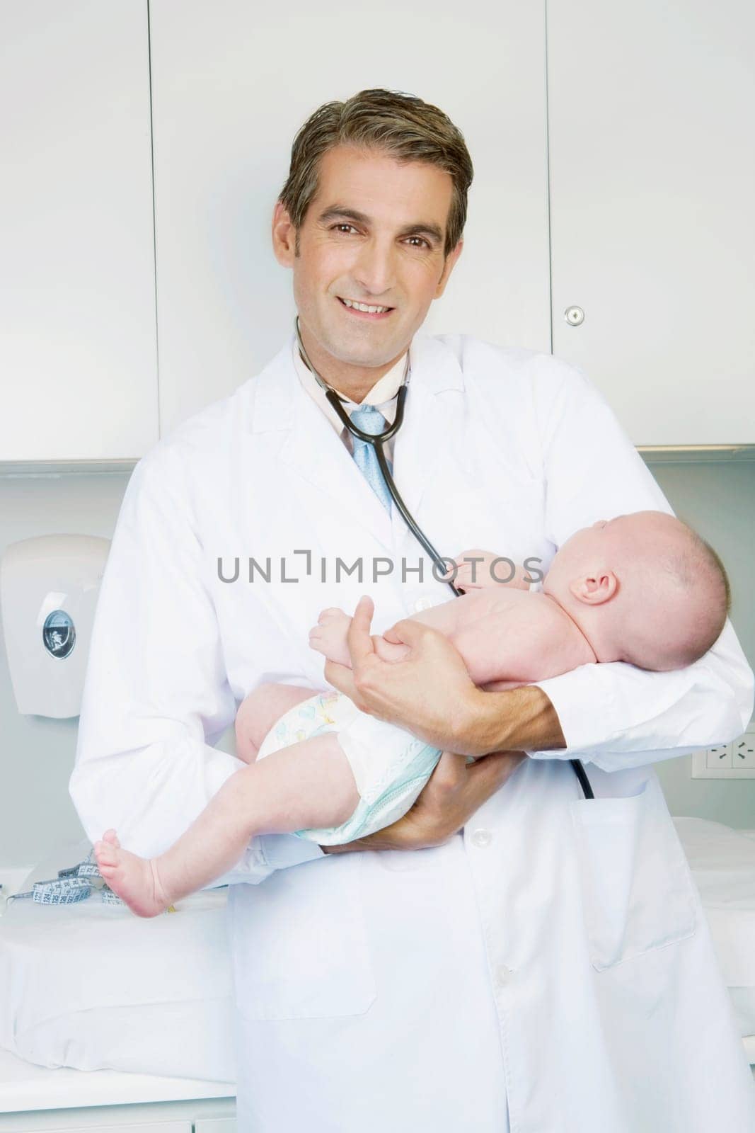 Doctor carrying a newborn baby
