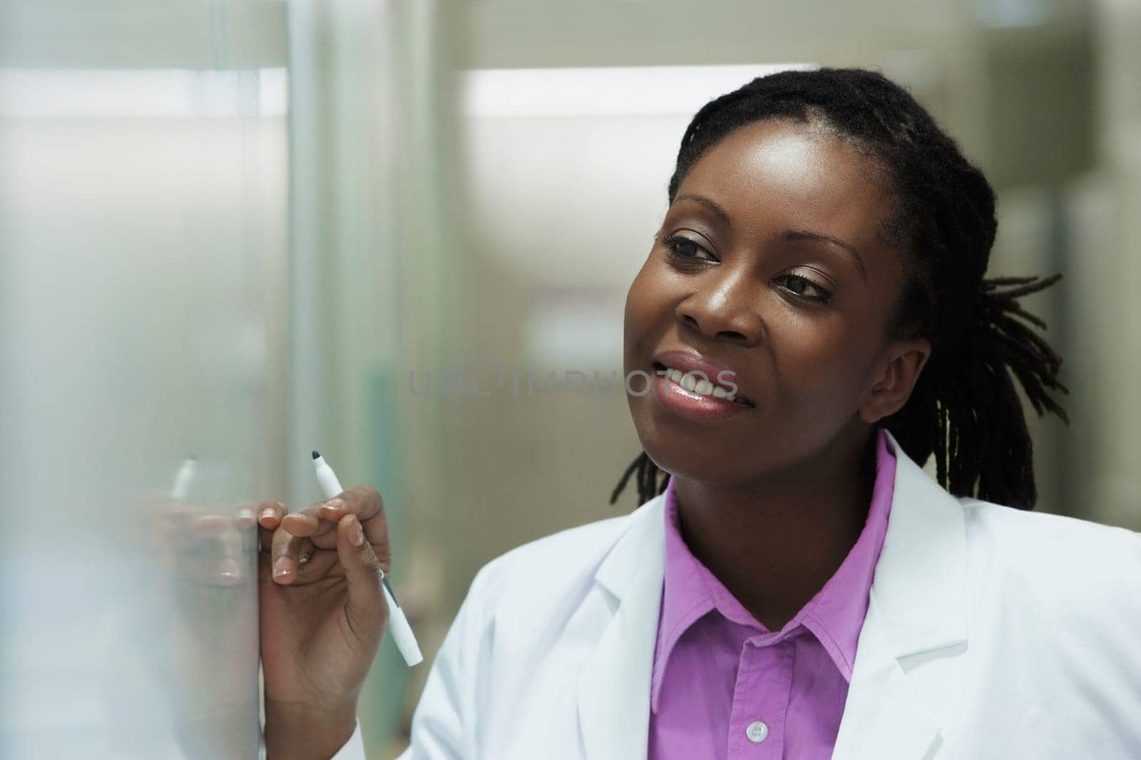 Female doctor writing on a whiteboard in a hospital