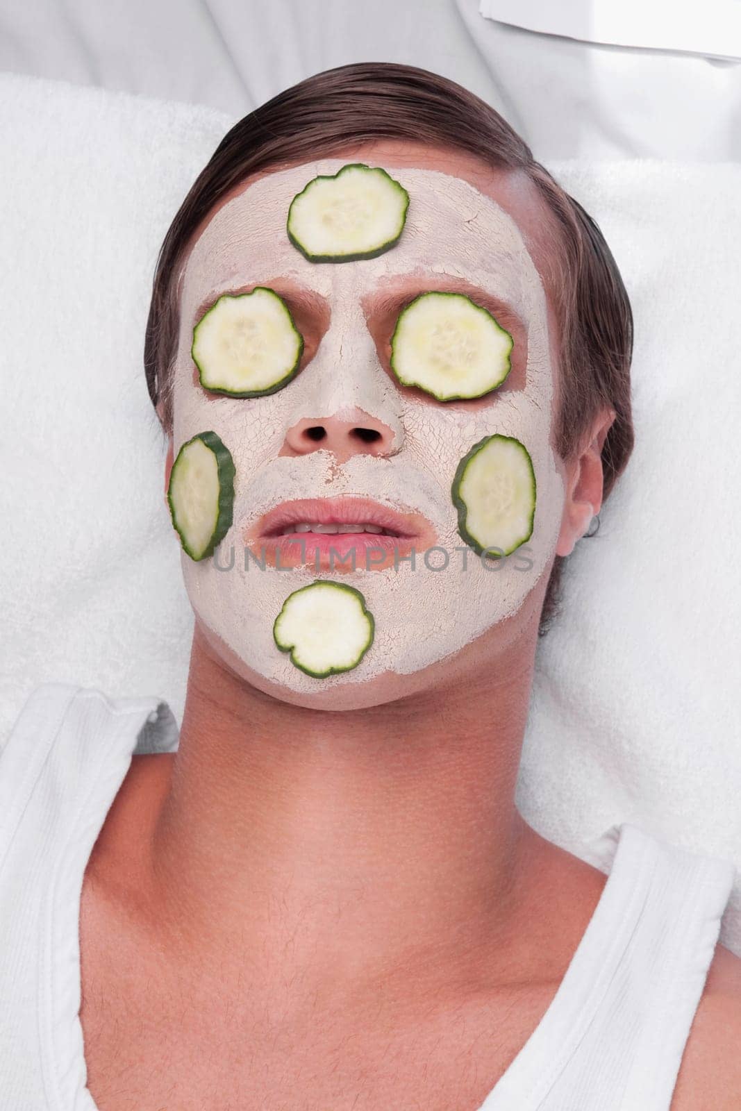 Cucumber slices on a manŽs face