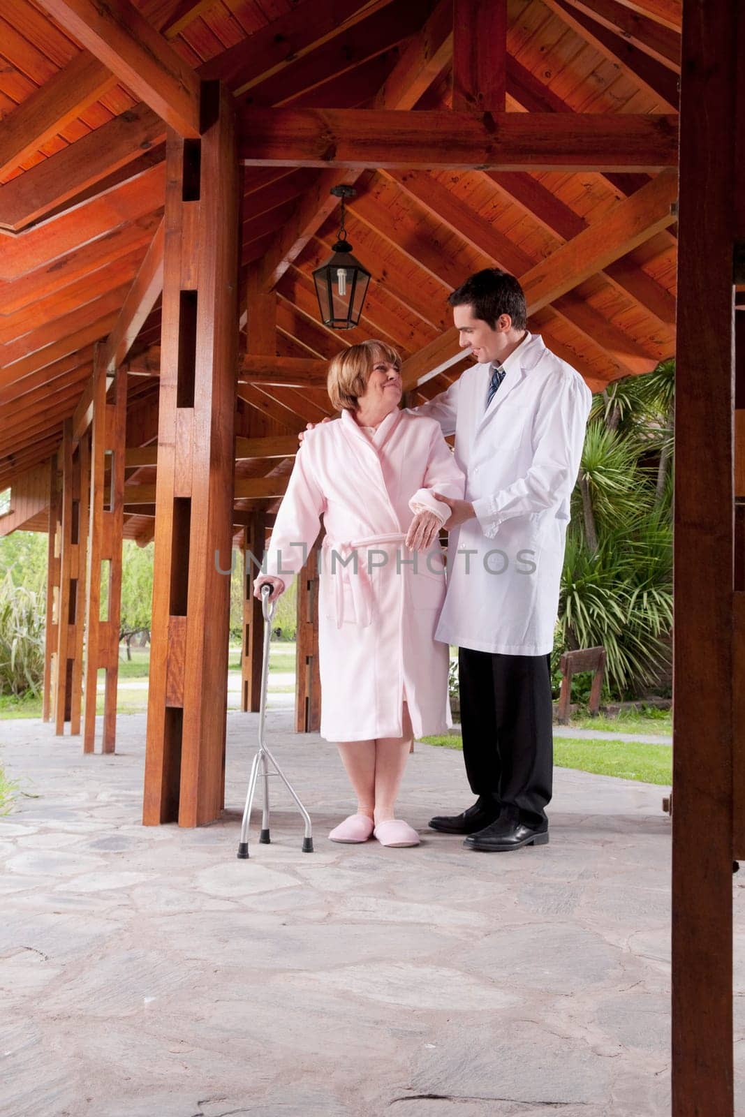 Doctor assisting a patient in walking in a rehabilitation centre
