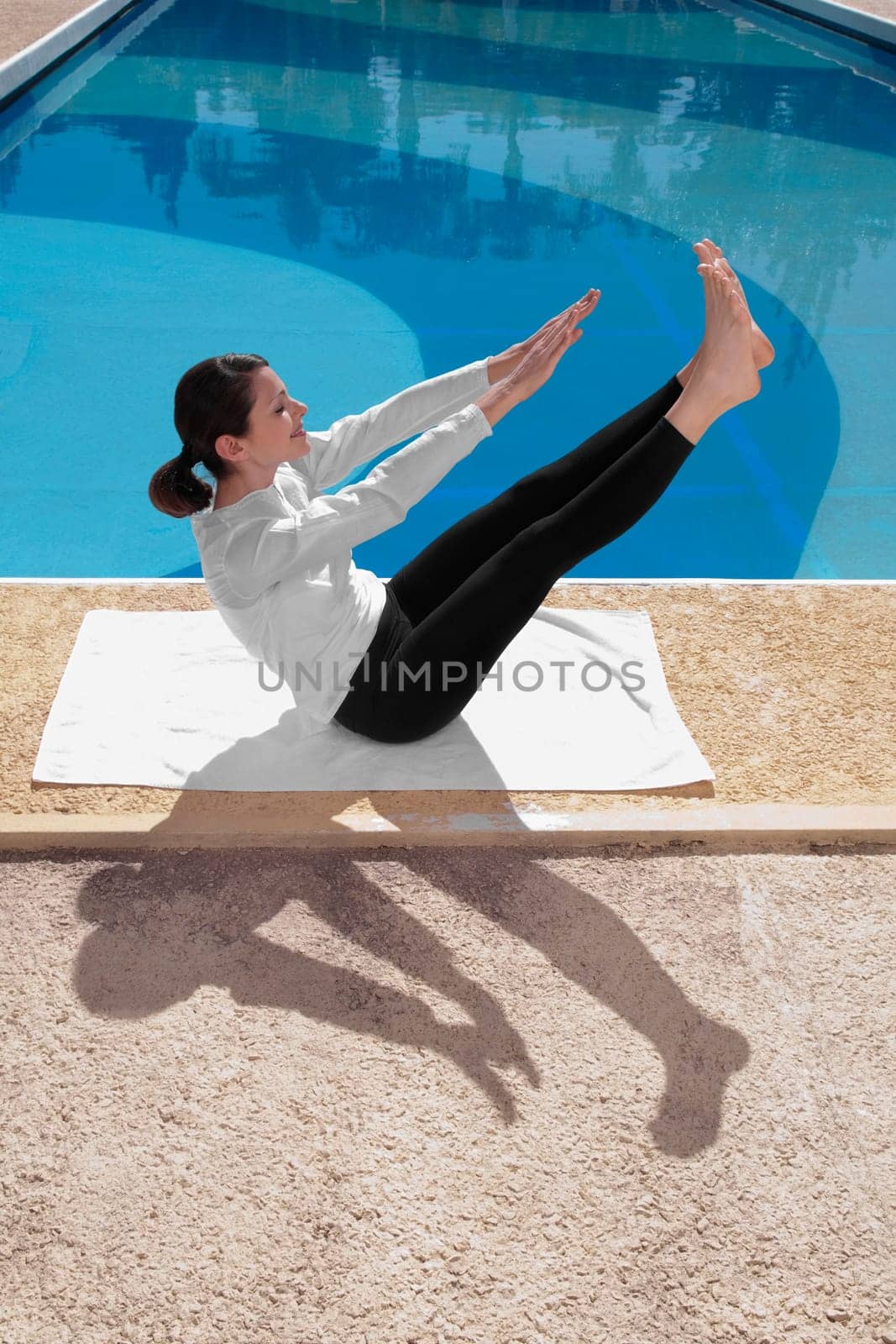 Woman exercising at the poolside