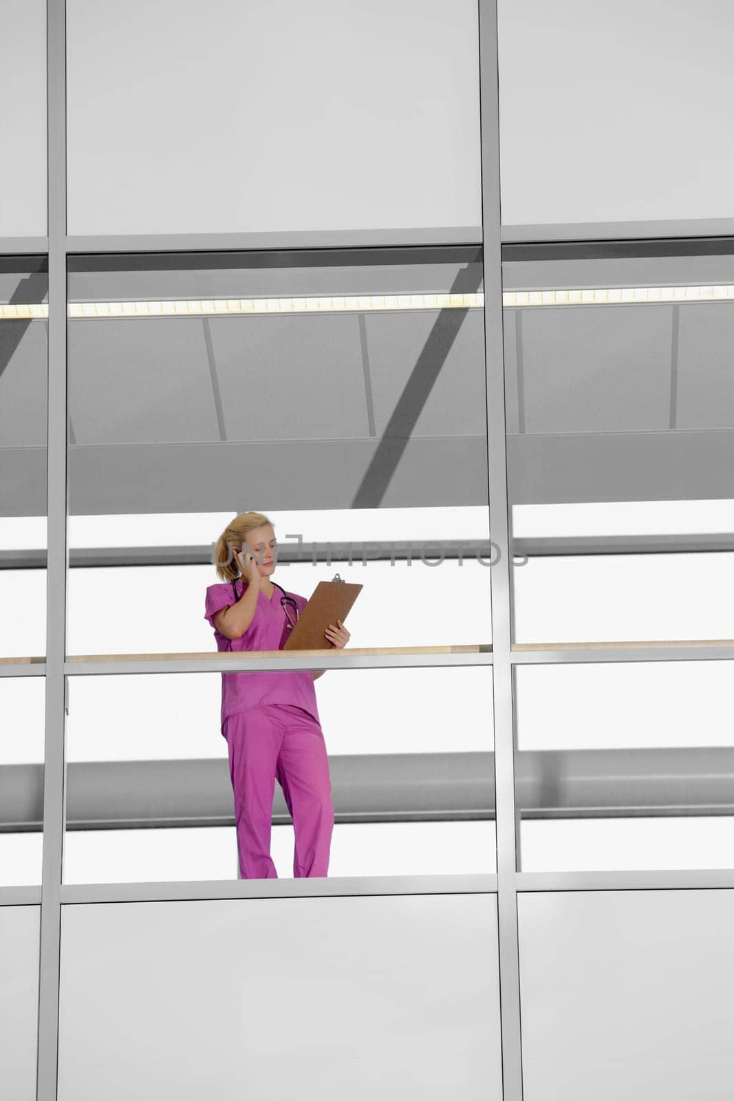 Female doctor talking on a mobile phone in a hospital
