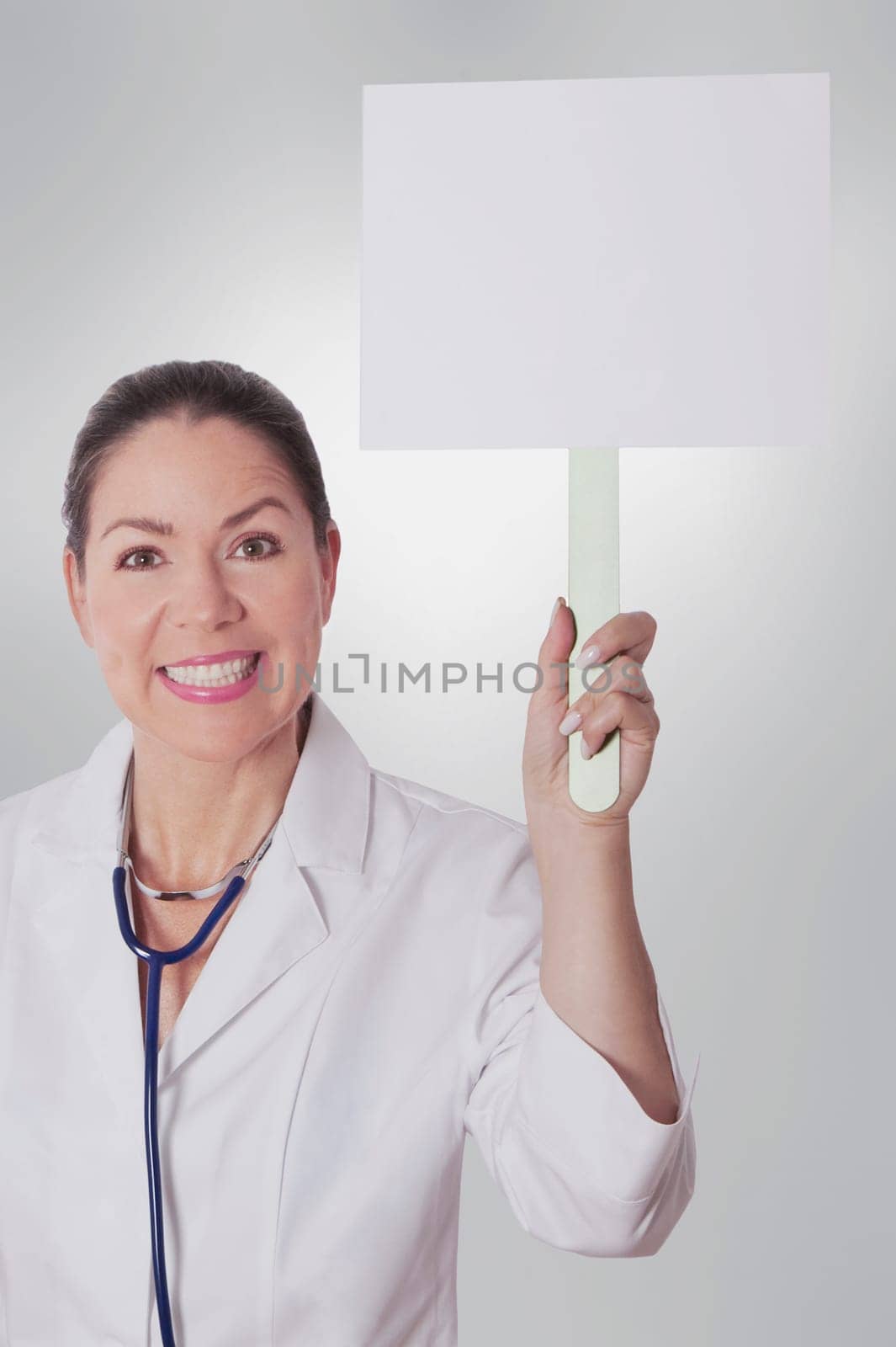 Female doctor holding a blank placard