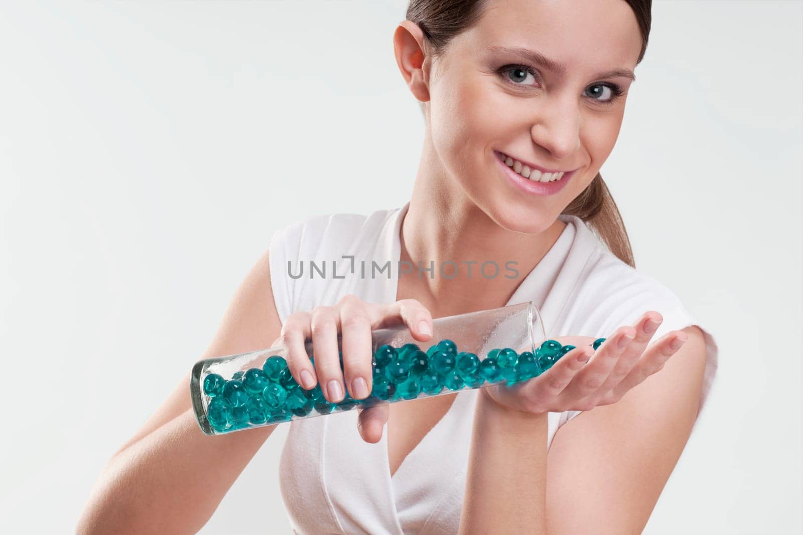 Woman pouring bath beads on her palm