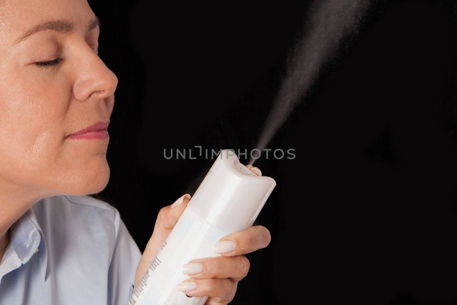 Woman holding a perfume sprayer