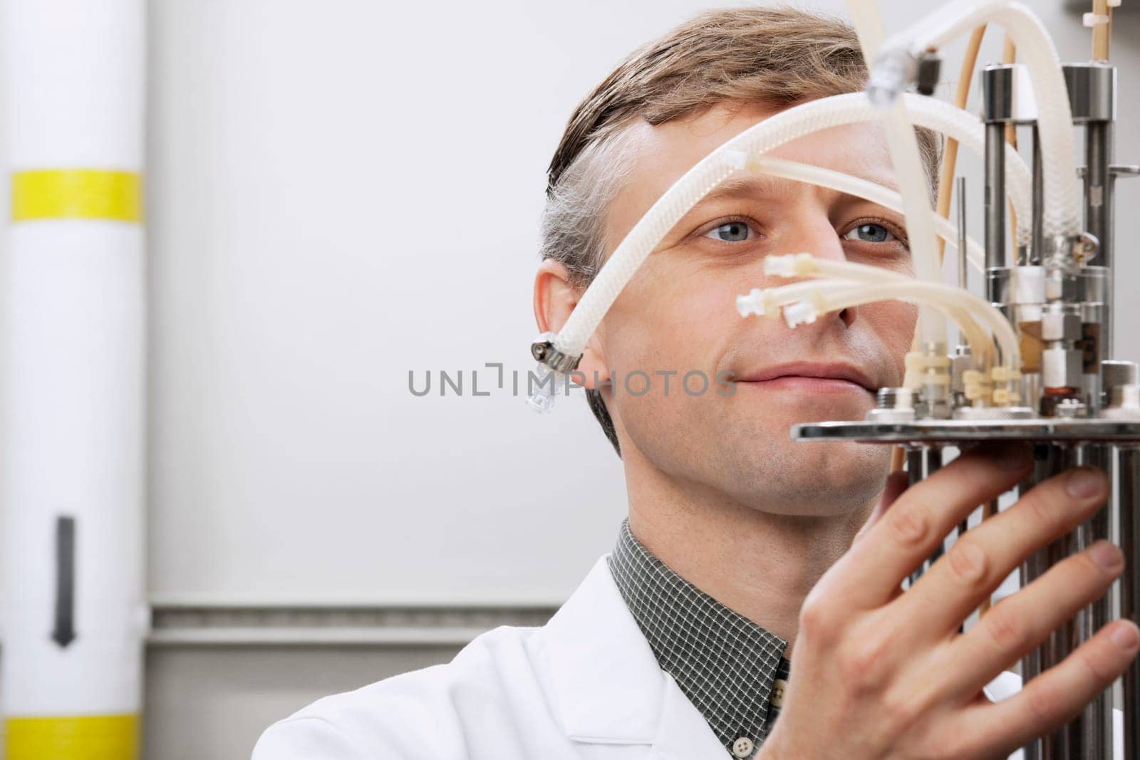 Scientist working on a bioreactor headplate with mixer assembly and methanol sensor probe