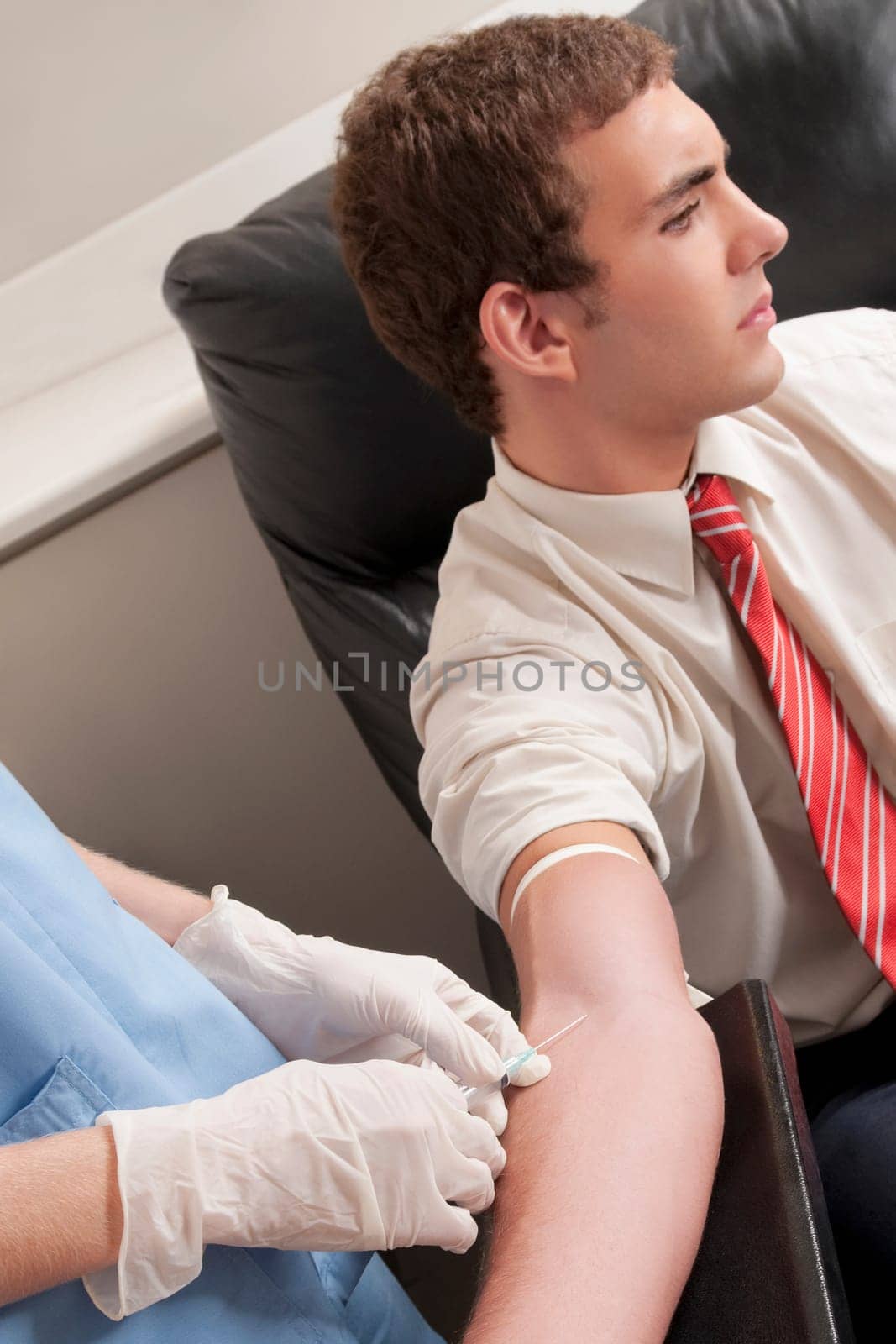 Doctor taking blood sample of a man