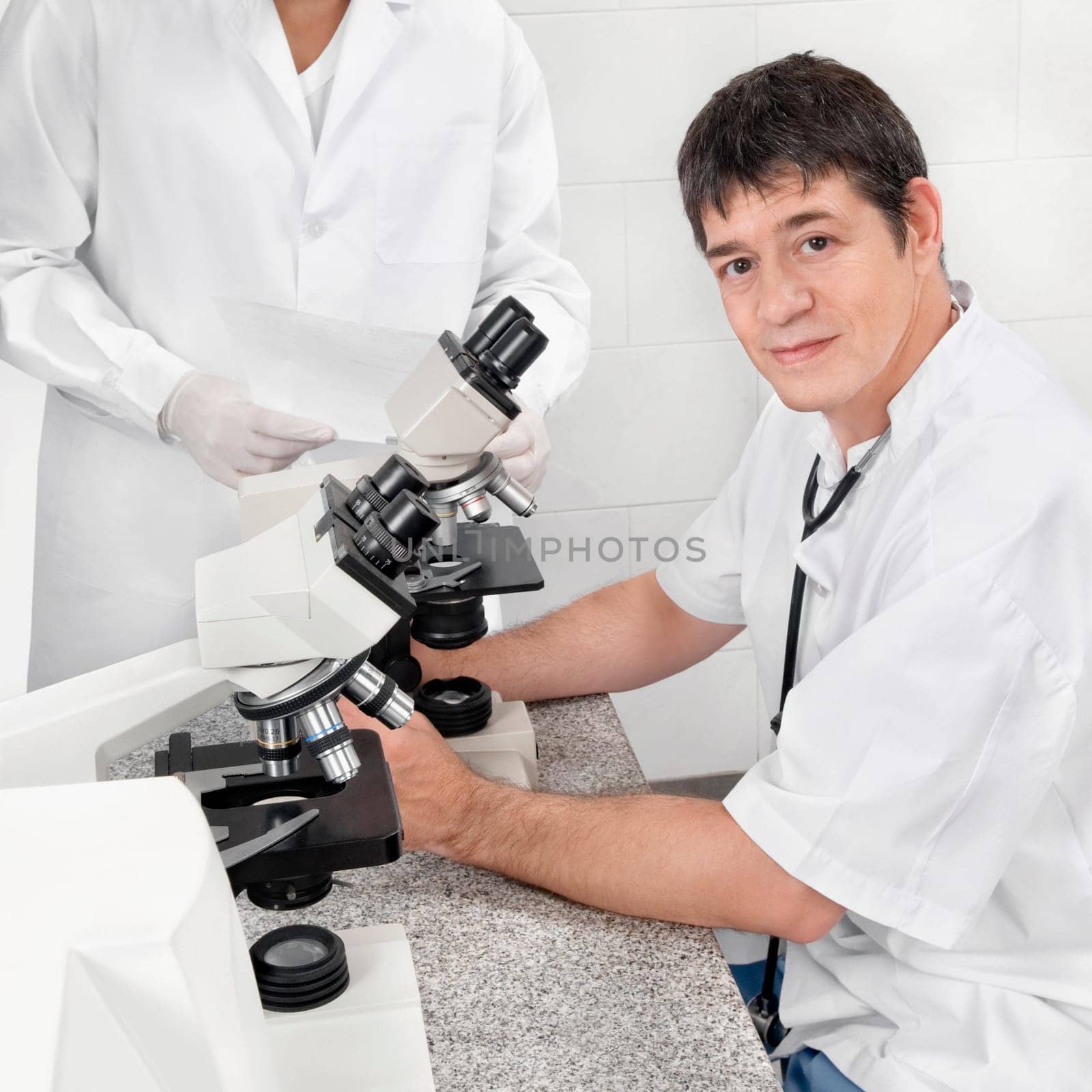 Vet looking into a microscope