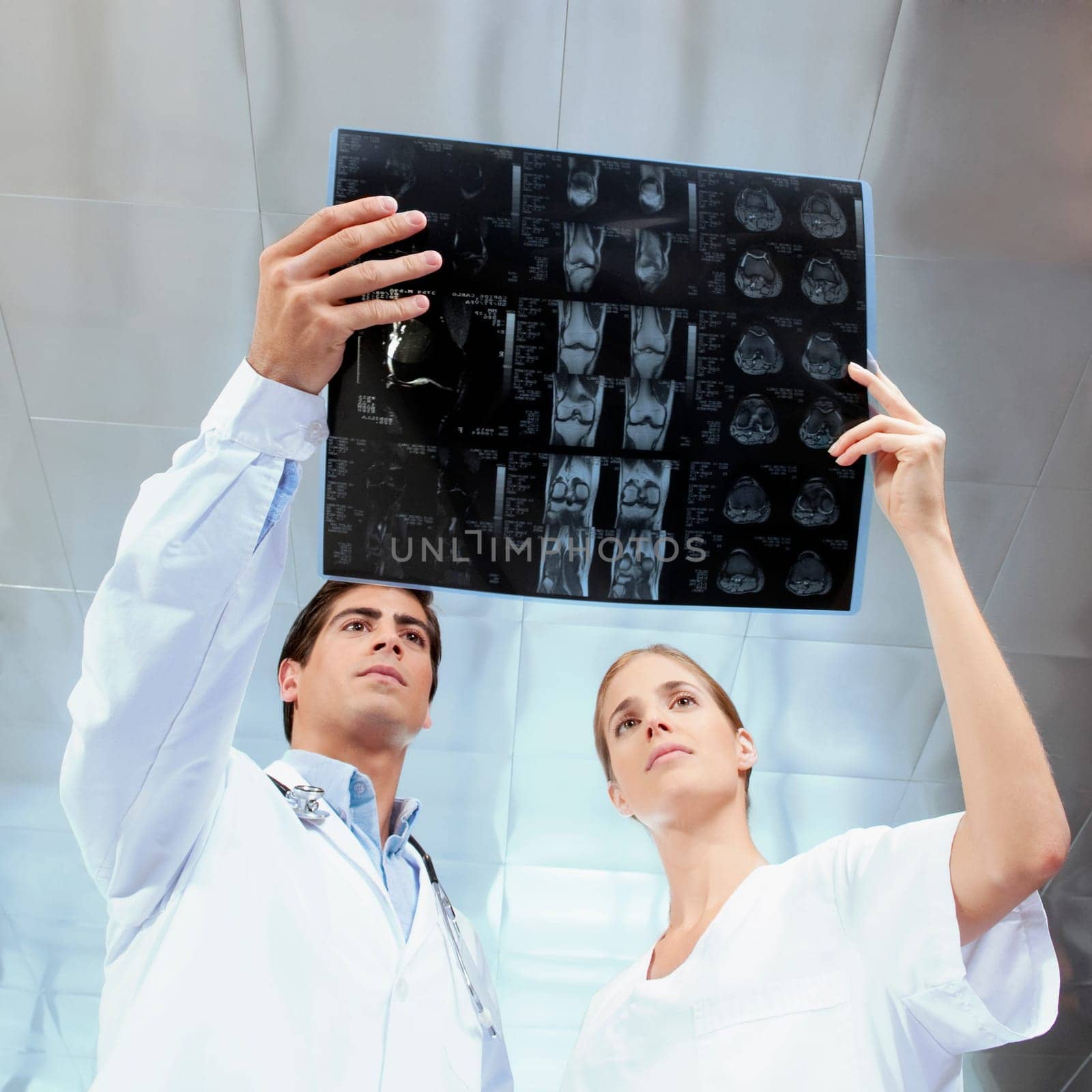 Doctor and a female nurse examining an x_ray report