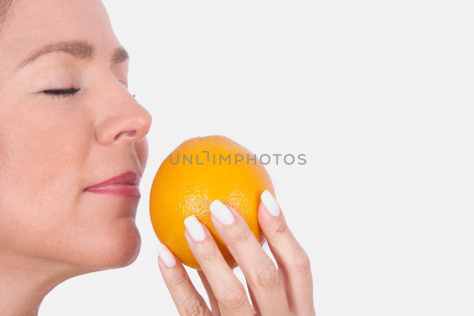Woman smelling an orange