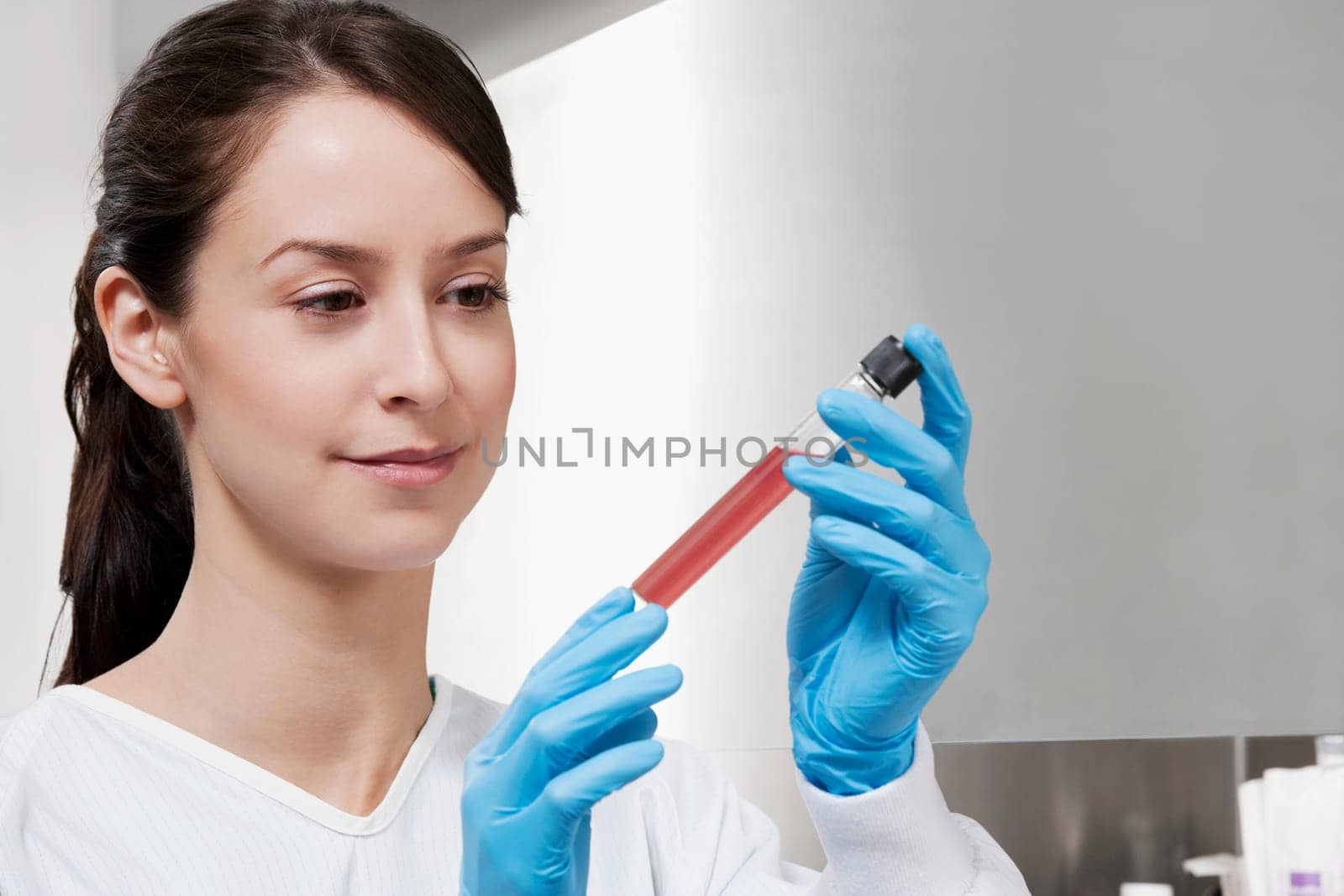 Female doctor holding a medical sample in a laboratory