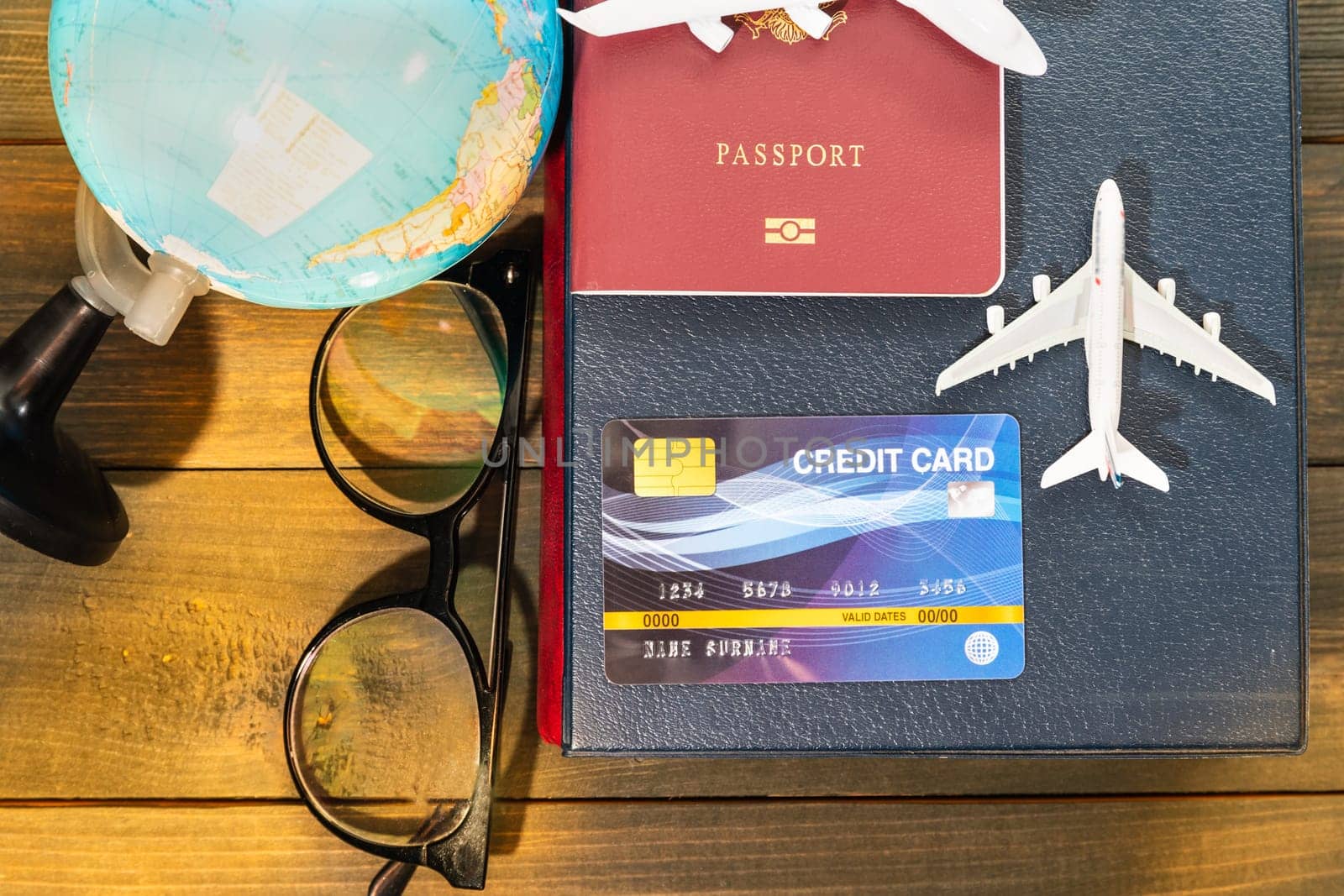 Credit card and airplane model on wooden table , Preparation for Traveling concept