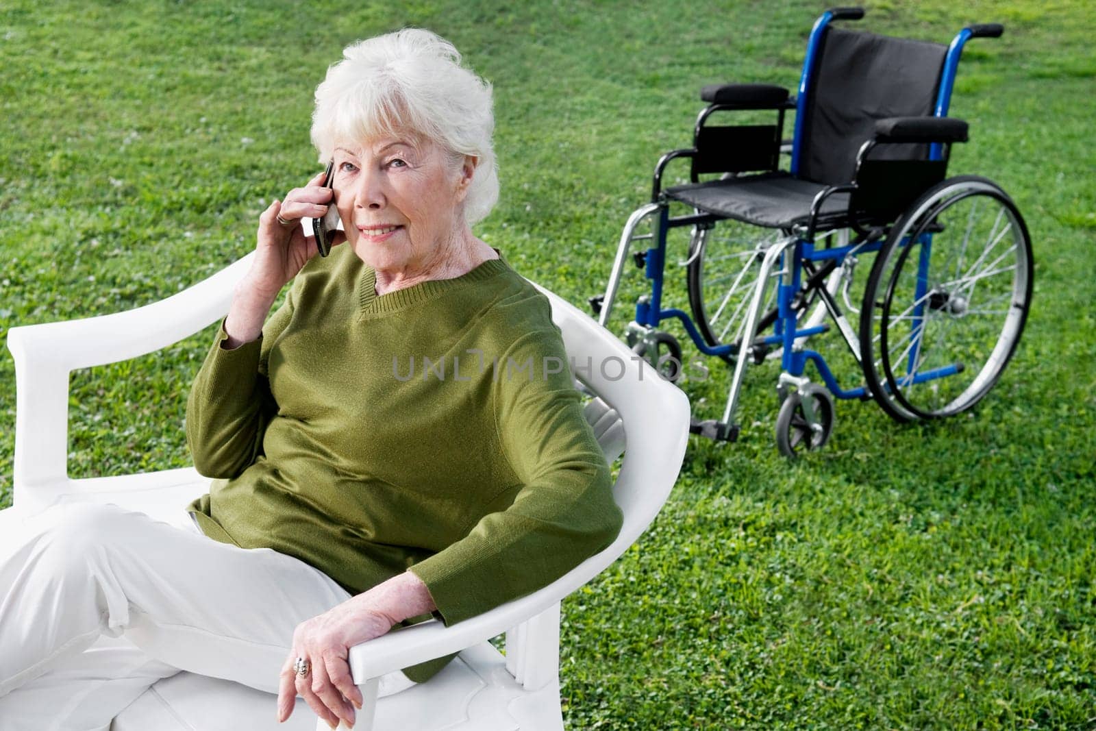 Woman sitting in a park and using a mobile phone