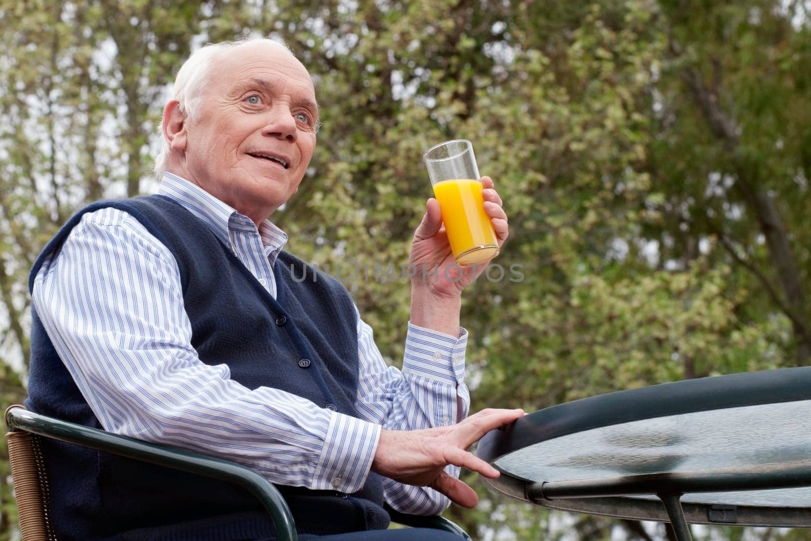 Man sitting on a chair and drinking juice
