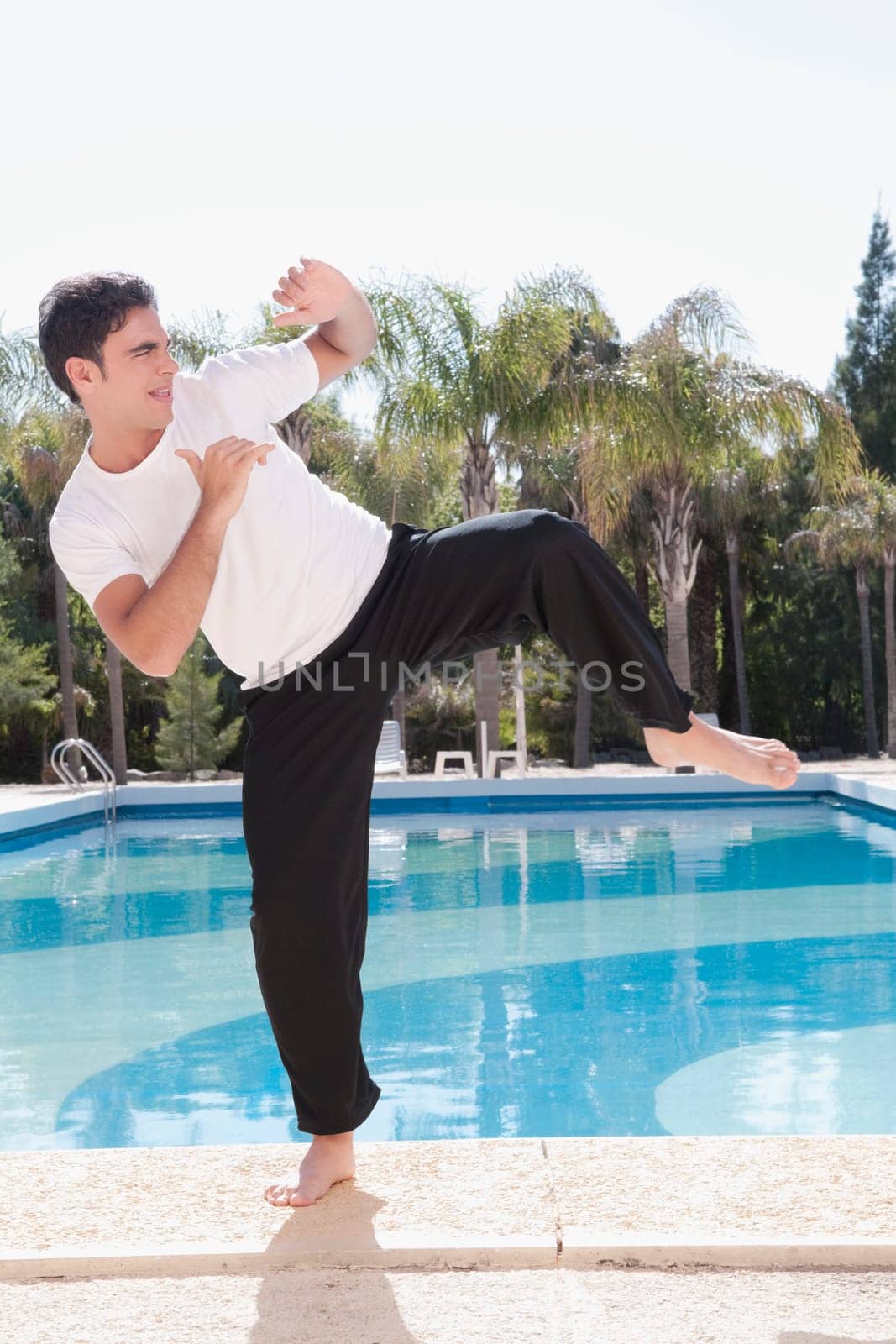 Man exercising at the poolside